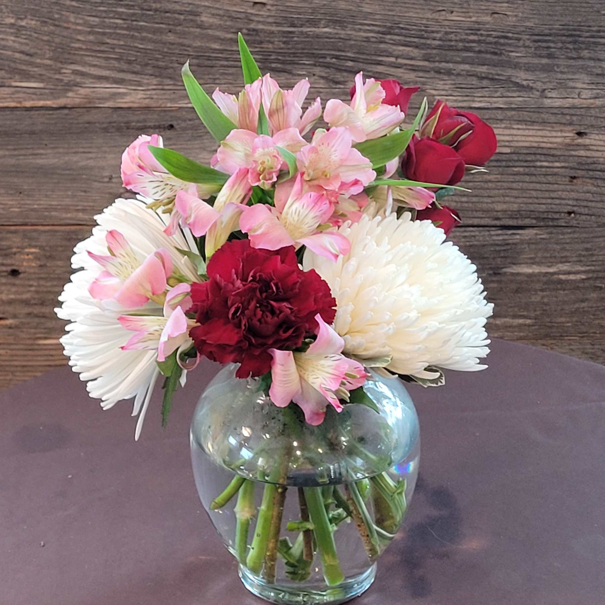 Cute little arrangement with bright colored flowers. Nice and compact for a