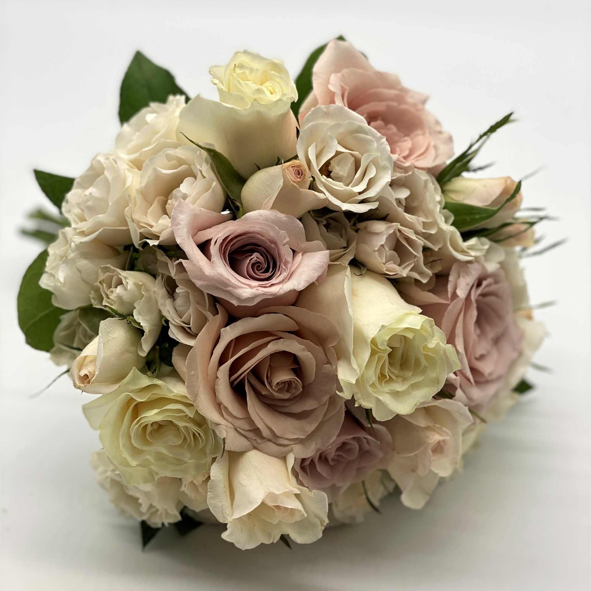A mix of dusty pinks, creams and lavenders gives this bouquet a