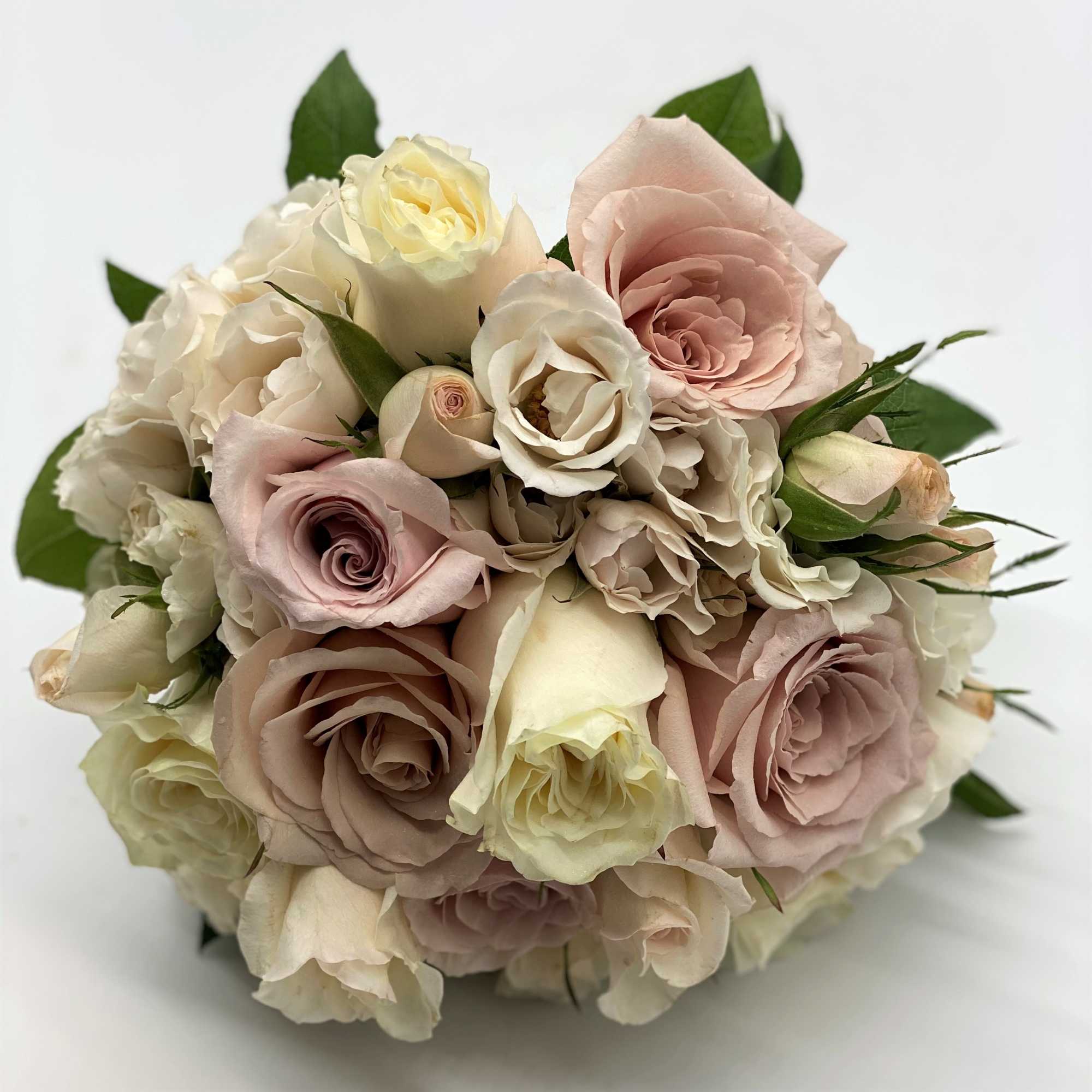 A mix of dusty pinks, creams and lavenders gives this bouquet a
