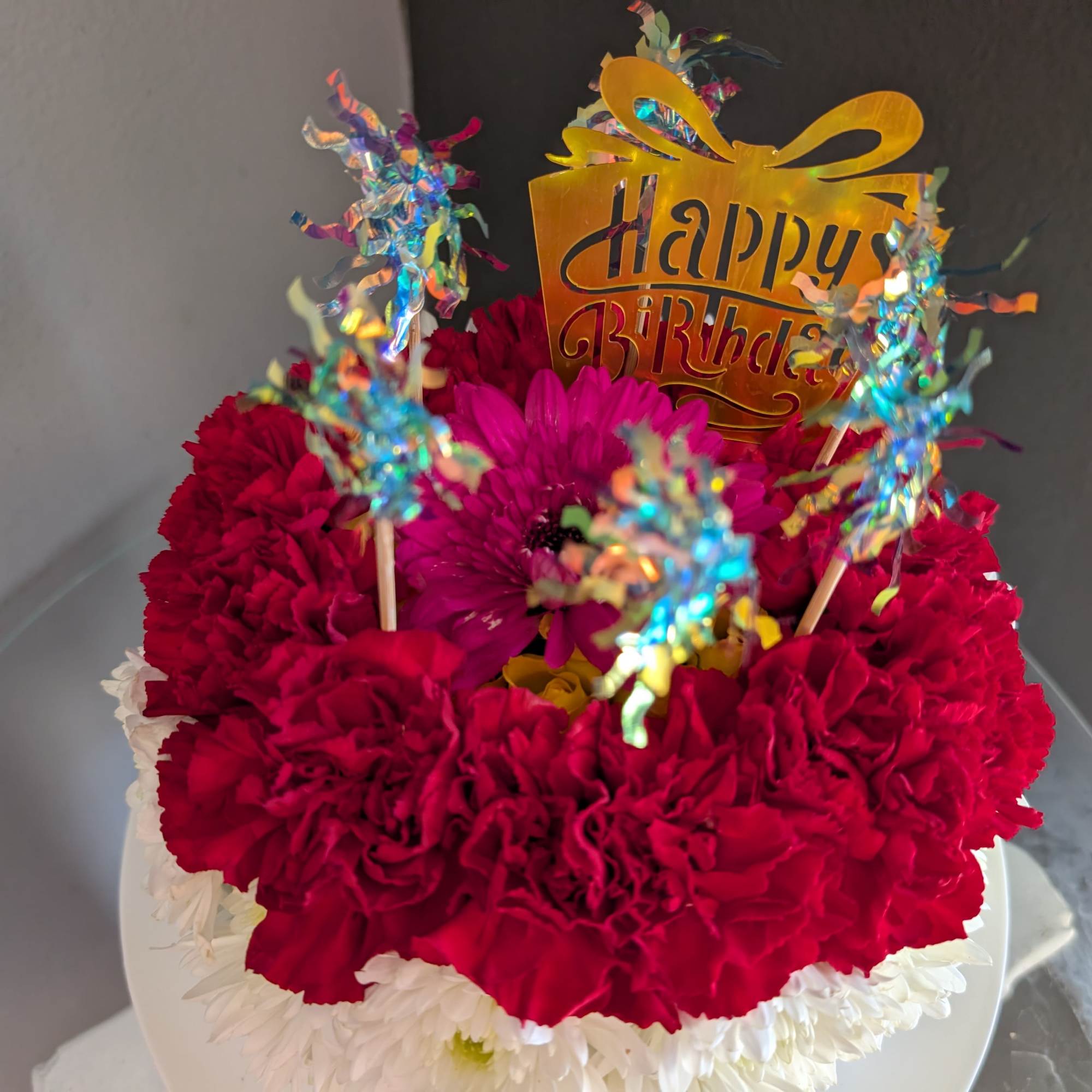 This adorable cake arrangement is sure to put a smile on any