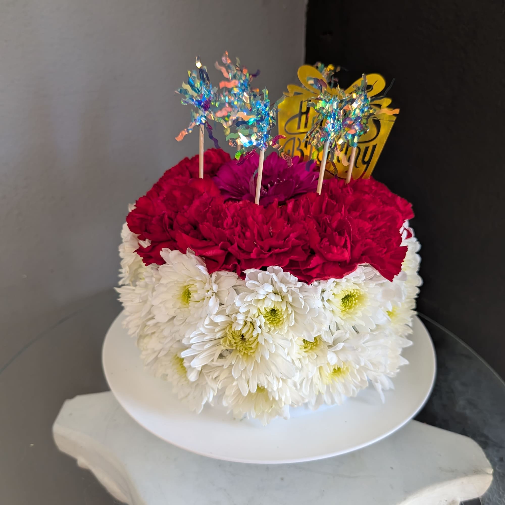 This adorable cake arrangement is sure to put a smile on any
