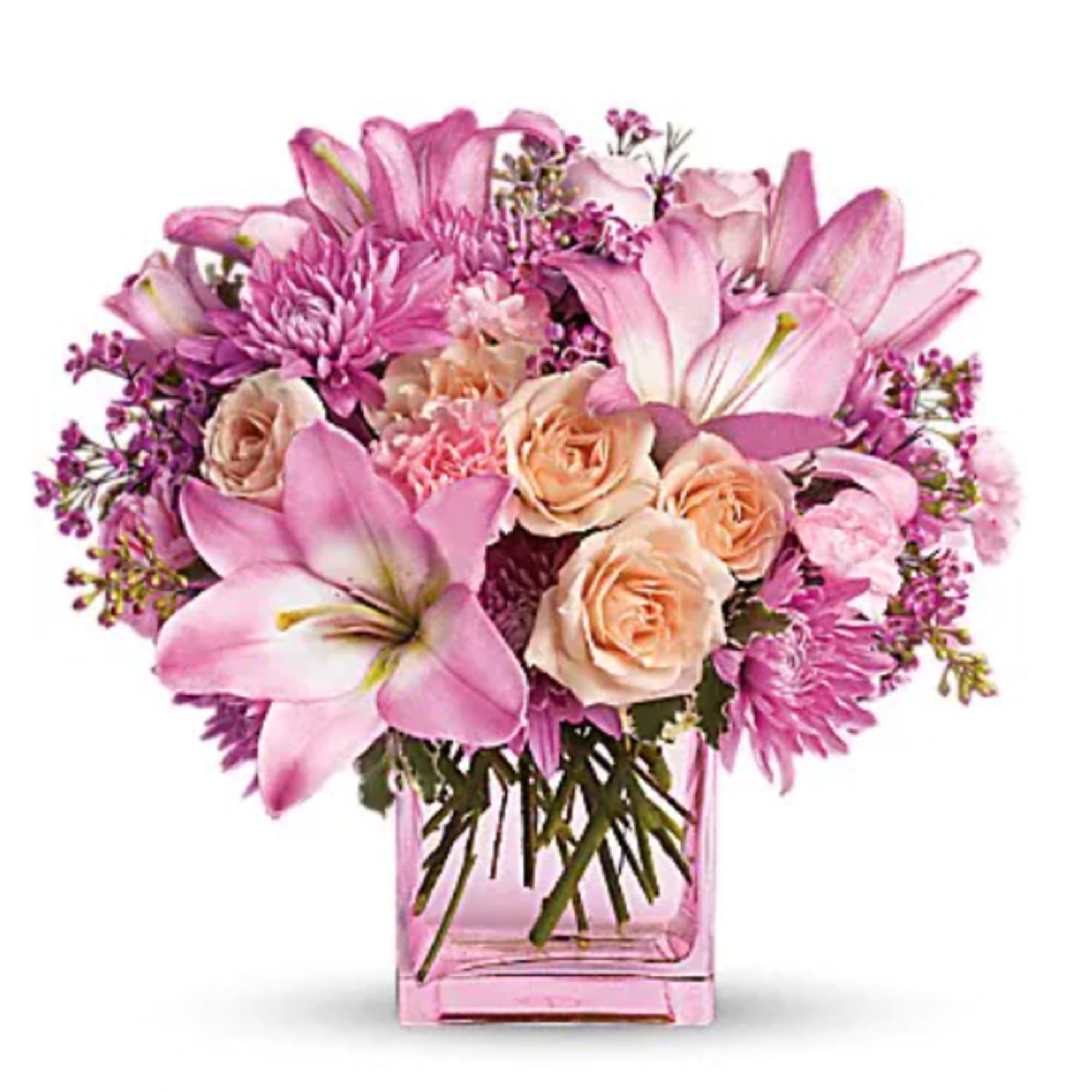 Pink and peach bouquet in a square glass vase