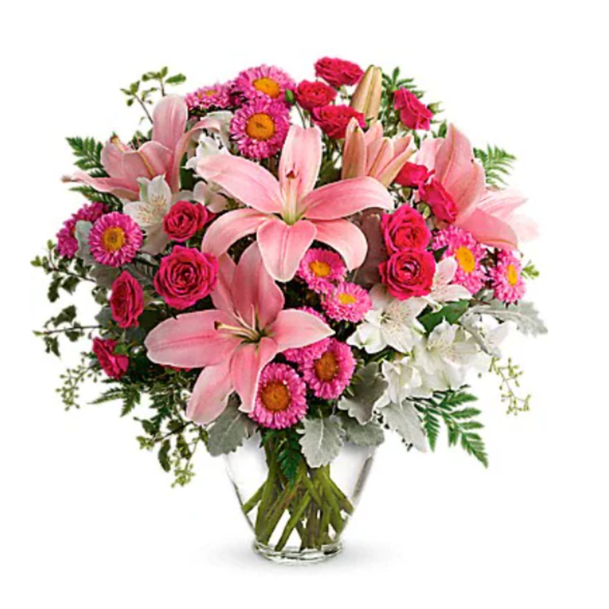Pink lilies and mixed flowers in a clear glass vase
