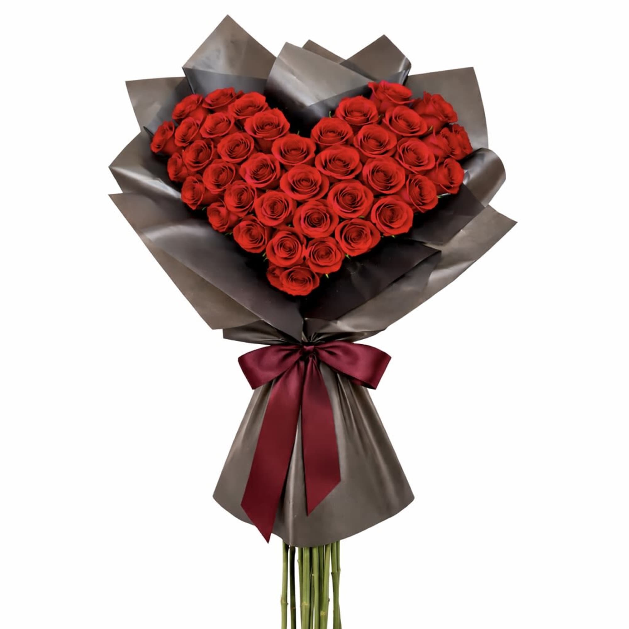 Heart-shaped bouquet of red roses wrapped in dark paper with a burgundy ribbon