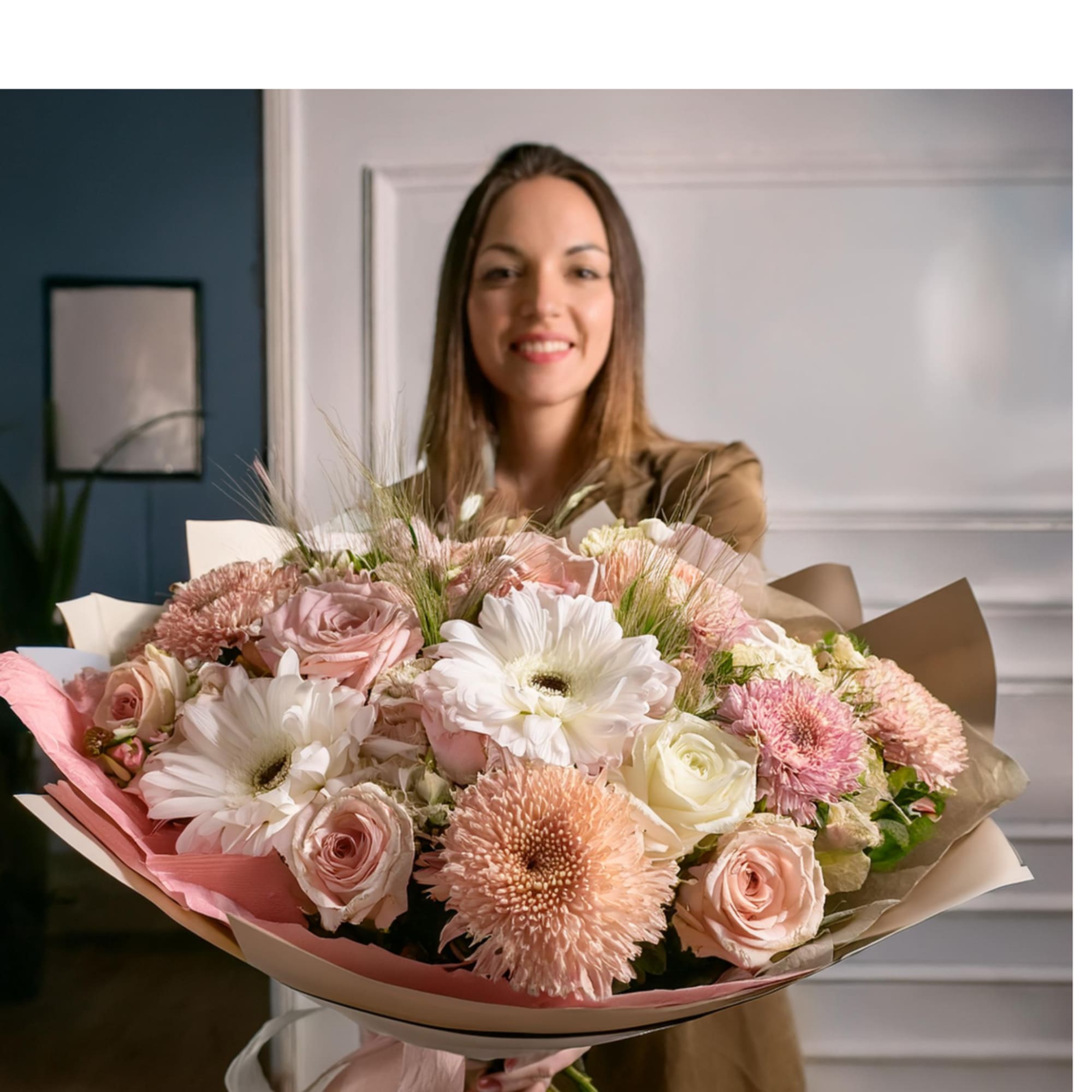 Woman holding a large bouquet of pink and white flowers