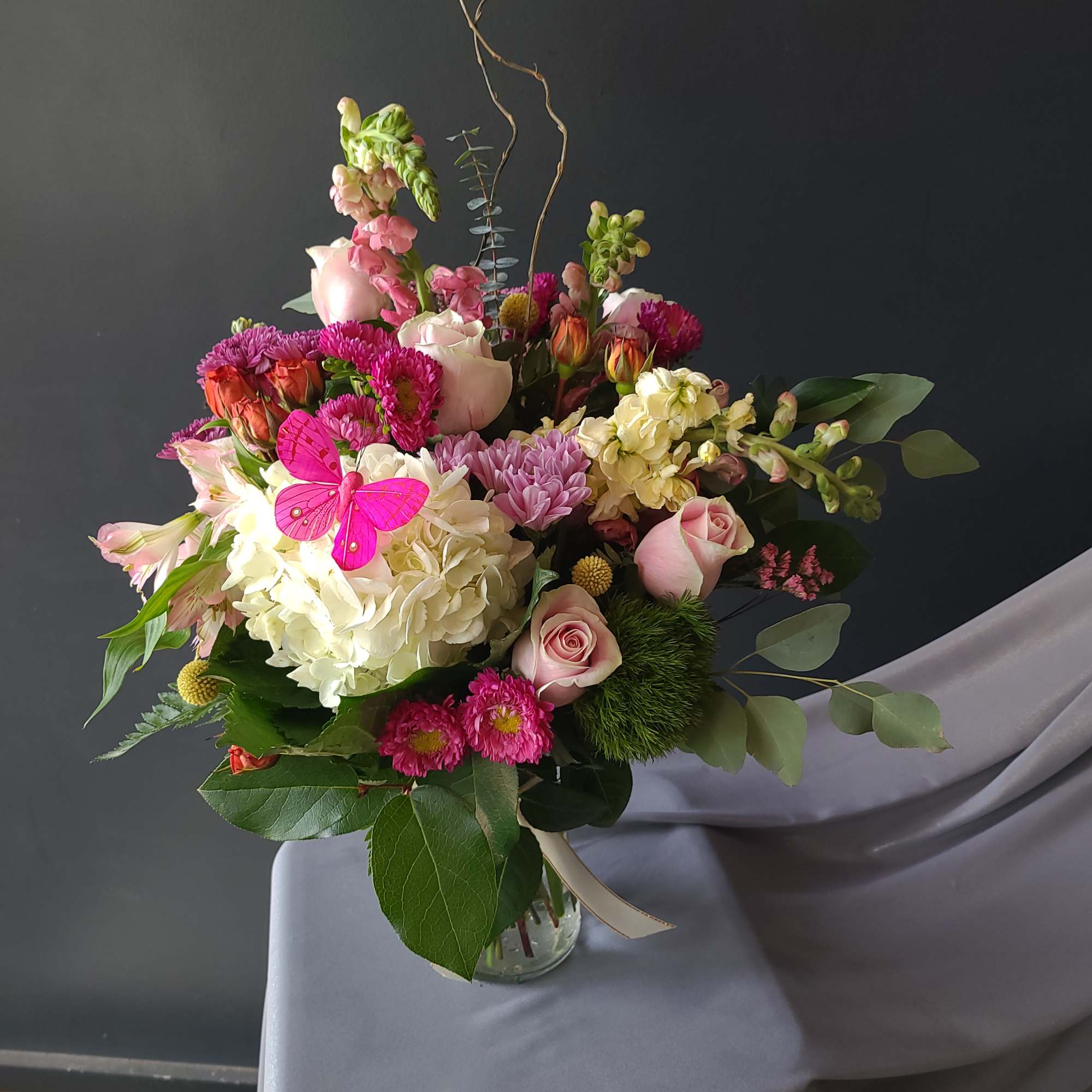 Mixed bouquet of pink and white flowers in a glass vase