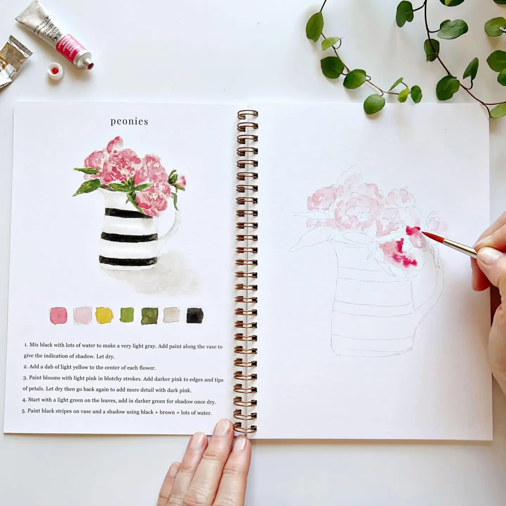 Spiral-bound watercolor workbook with step-by-step instructions 