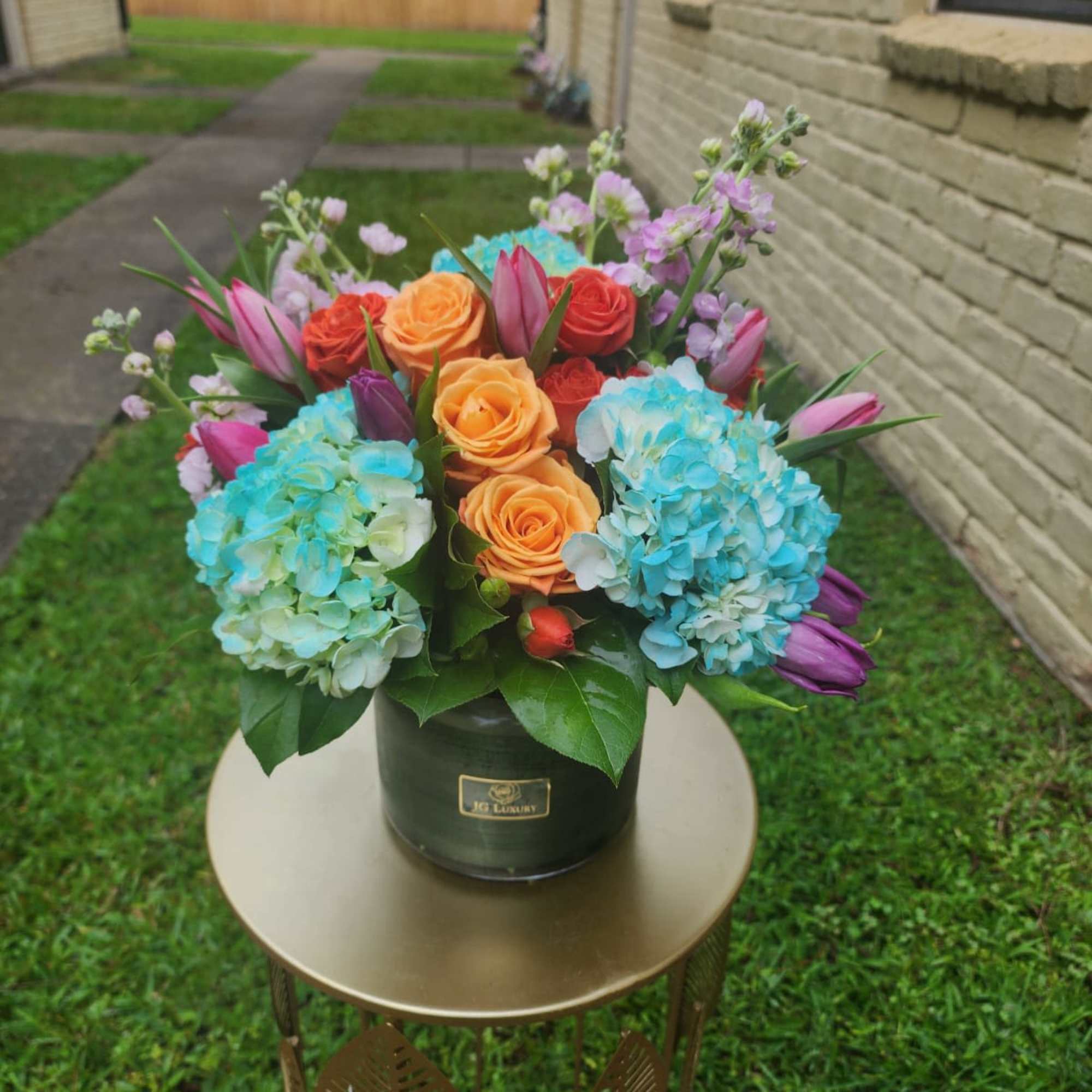 Tulips, roses, hydrangeas, spray roses, all arranged together to create smiles.