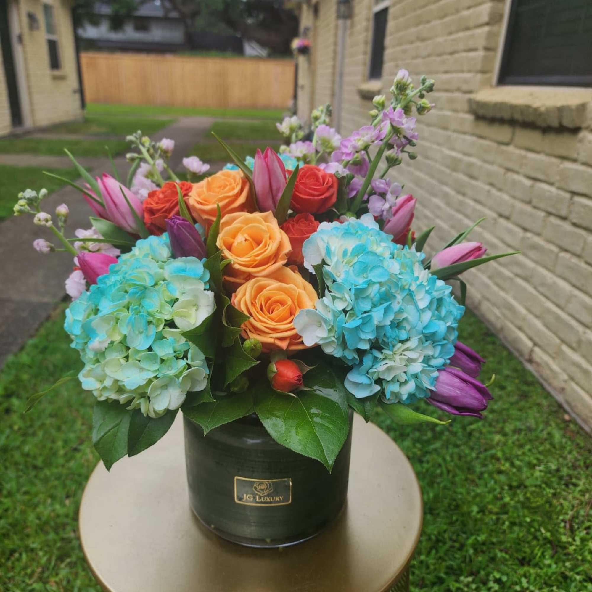 Tulips, roses, hydrangeas, spray roses, all arranged together to create smiles.