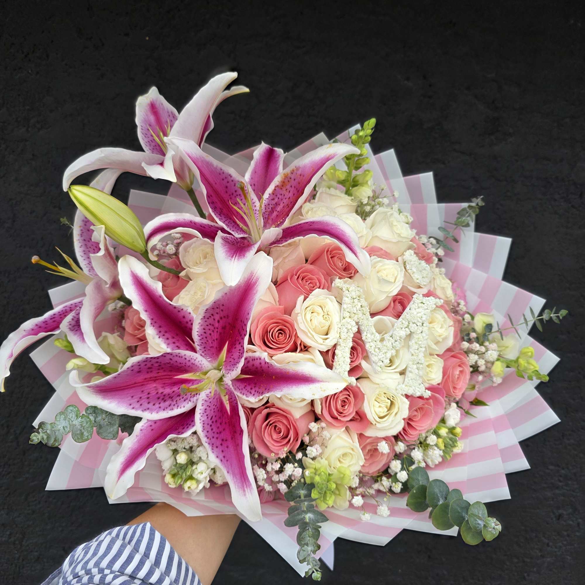 Velvety pink and ivory roses mingle with large pink-and-white oriental lilies in