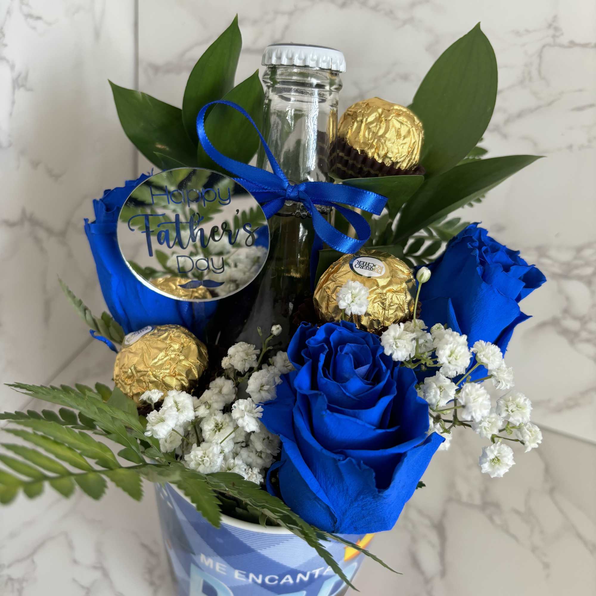 Vivid blue roses clustered with white filler blooms make this Father's Day