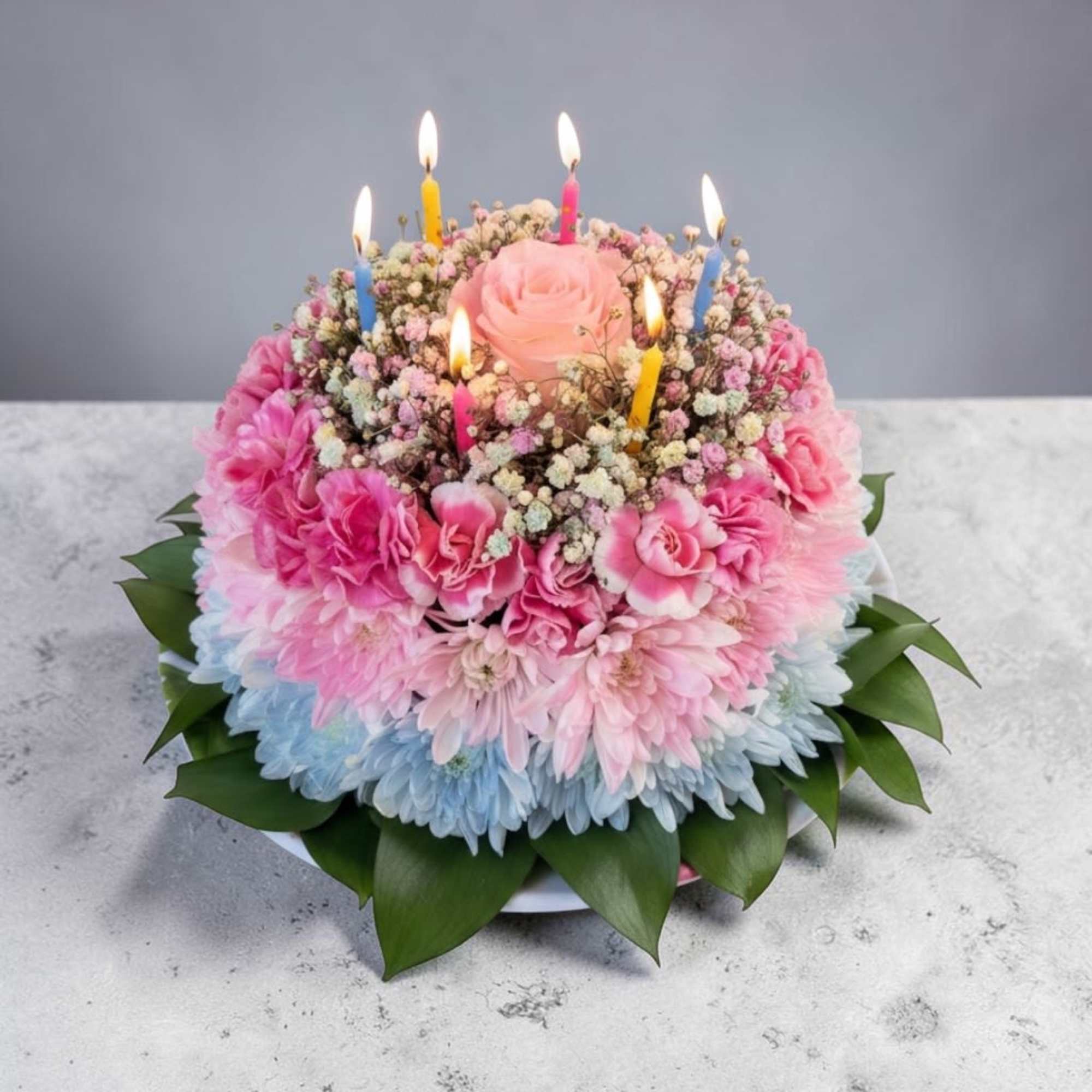 A pink-and-white floral "cake" arrangement shaped like a celebration centerpiece-perfect as a