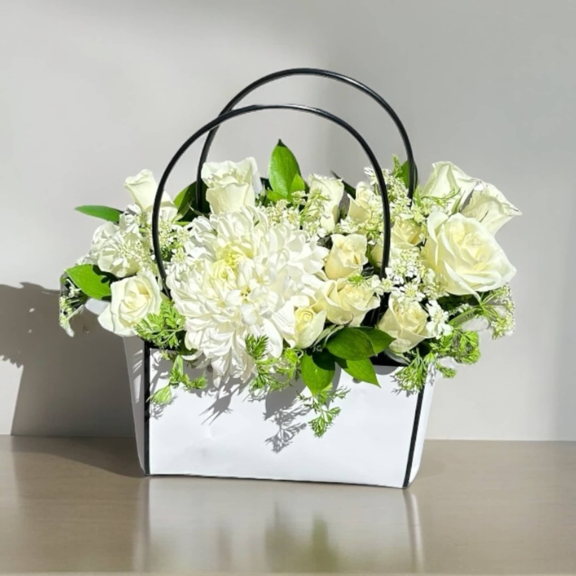 Our Designer&rsquo;s Choice In A Bag arrangement is a modern and elegant
