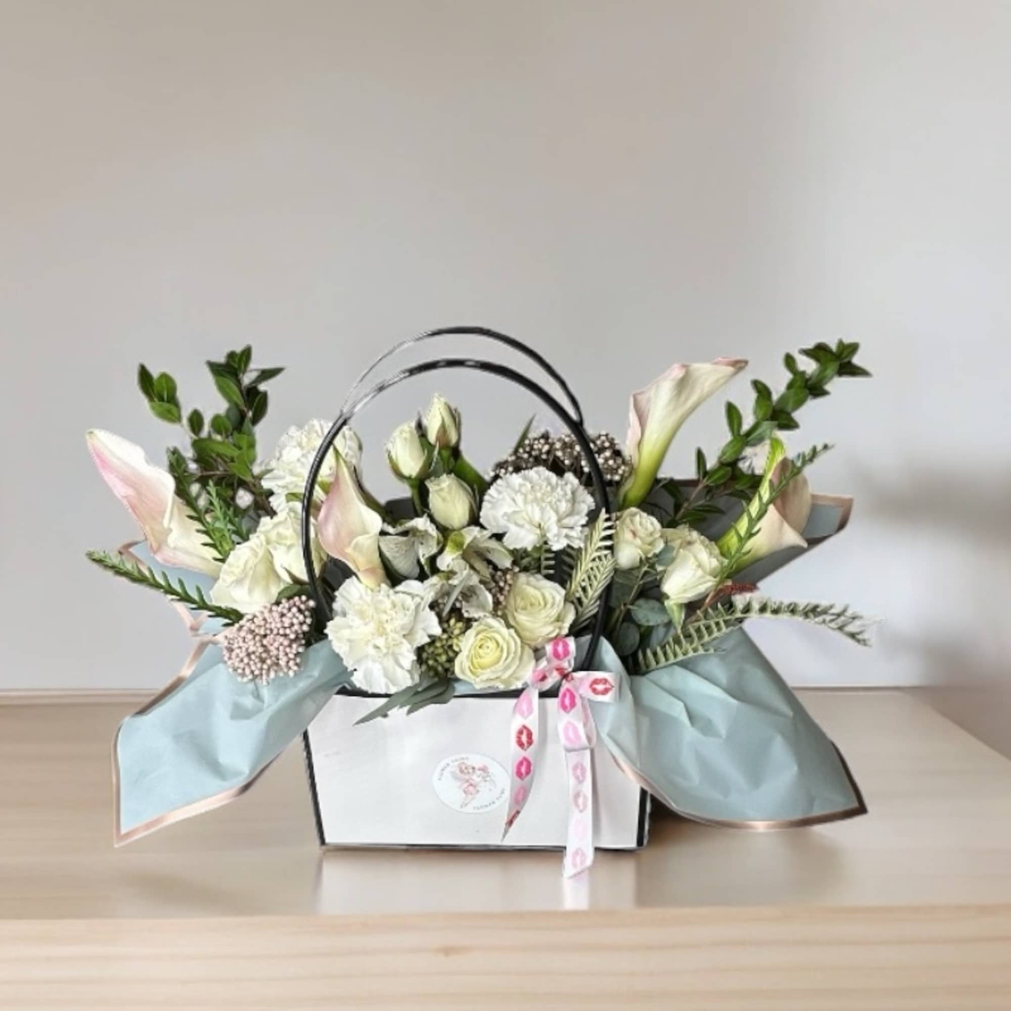 Our Designer&rsquo;s Choice In A Bag arrangement is a modern and elegant