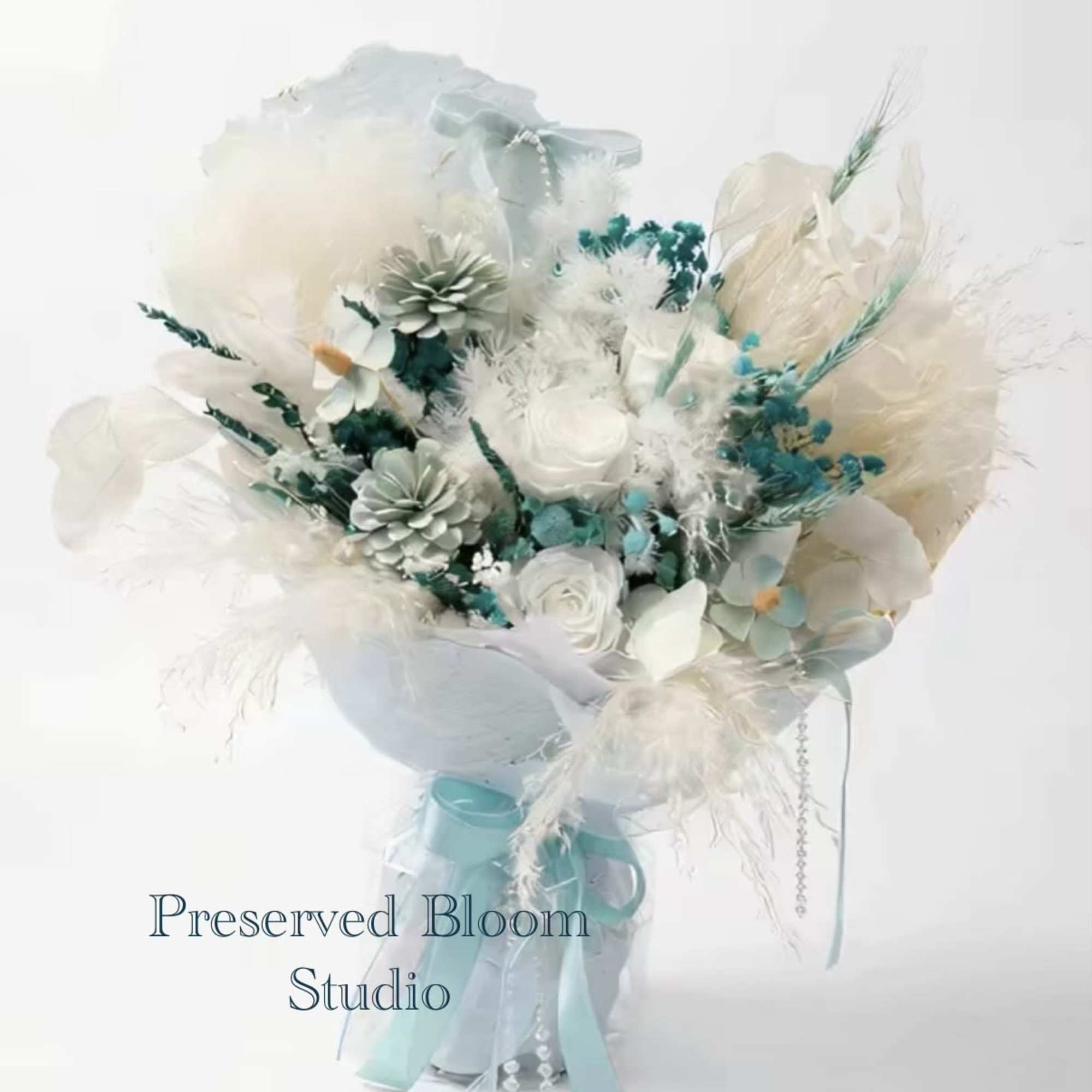 White and pale blue bouquet with ribbon and decorative accents