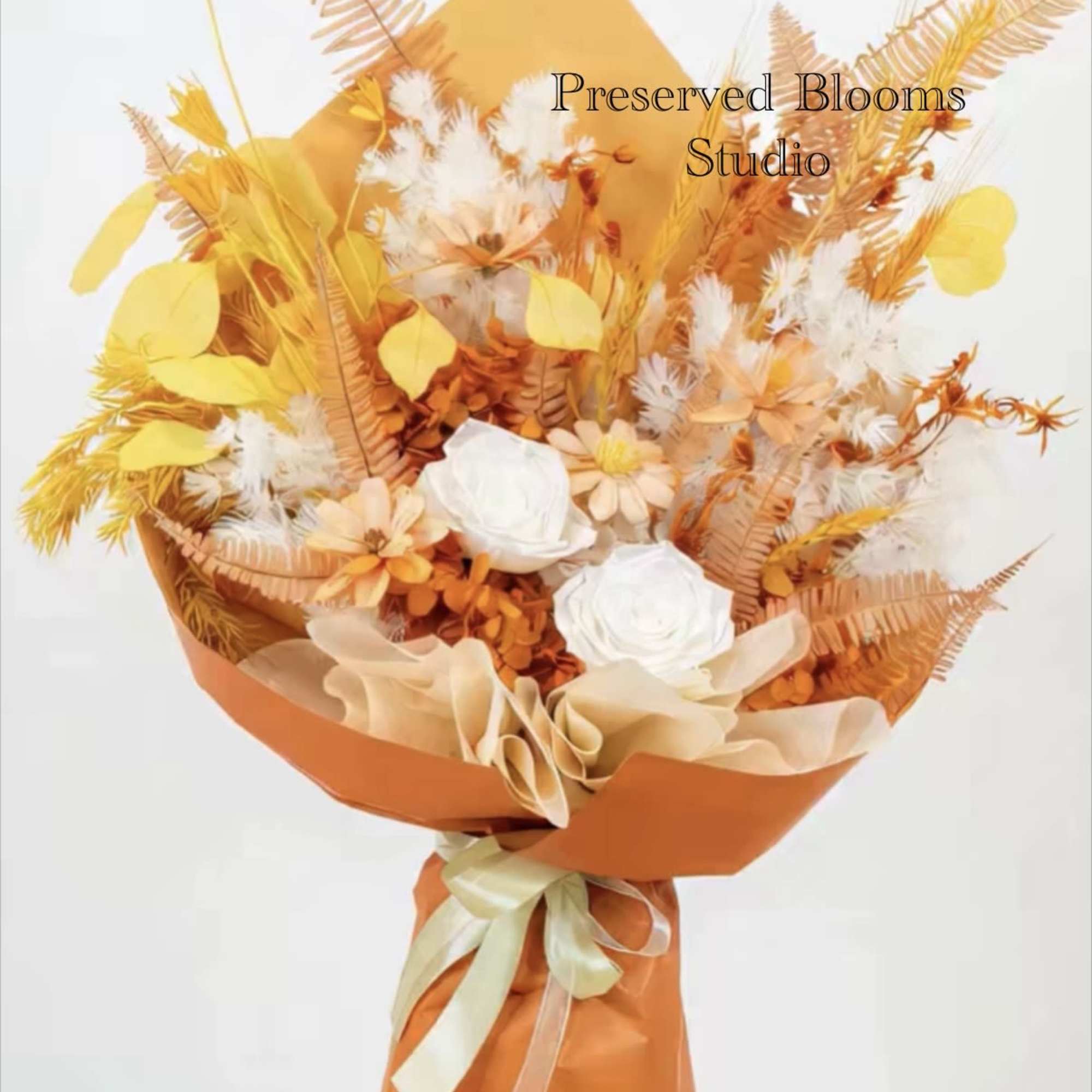 Tall bouquet of orange and yellow dried flowers with white roses wrapped in orange paper with ribbon