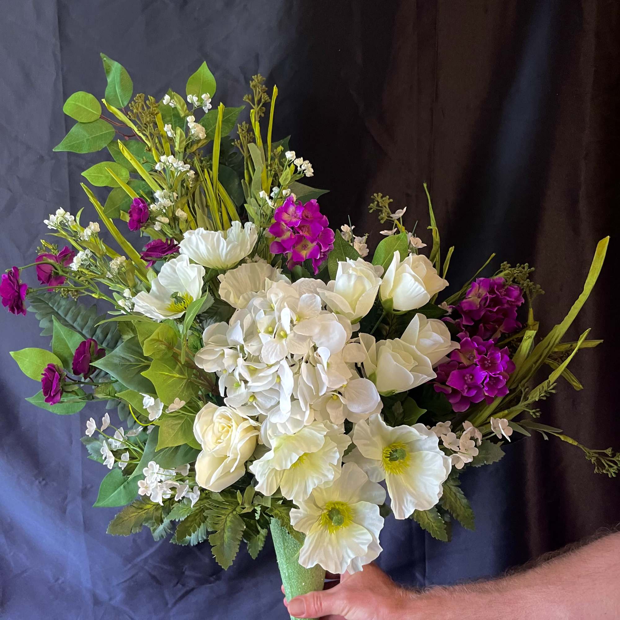 A concentrated cloud of crisp white blooms-hydrangeas and anemone-like flowers-forms the heart
