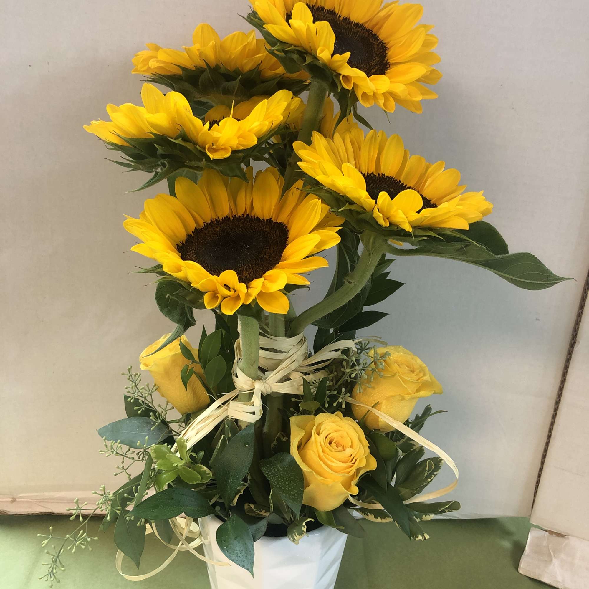 Topiary constructed of Sunflowers, Roses &amp; Assorted  Greens.
Note:   There