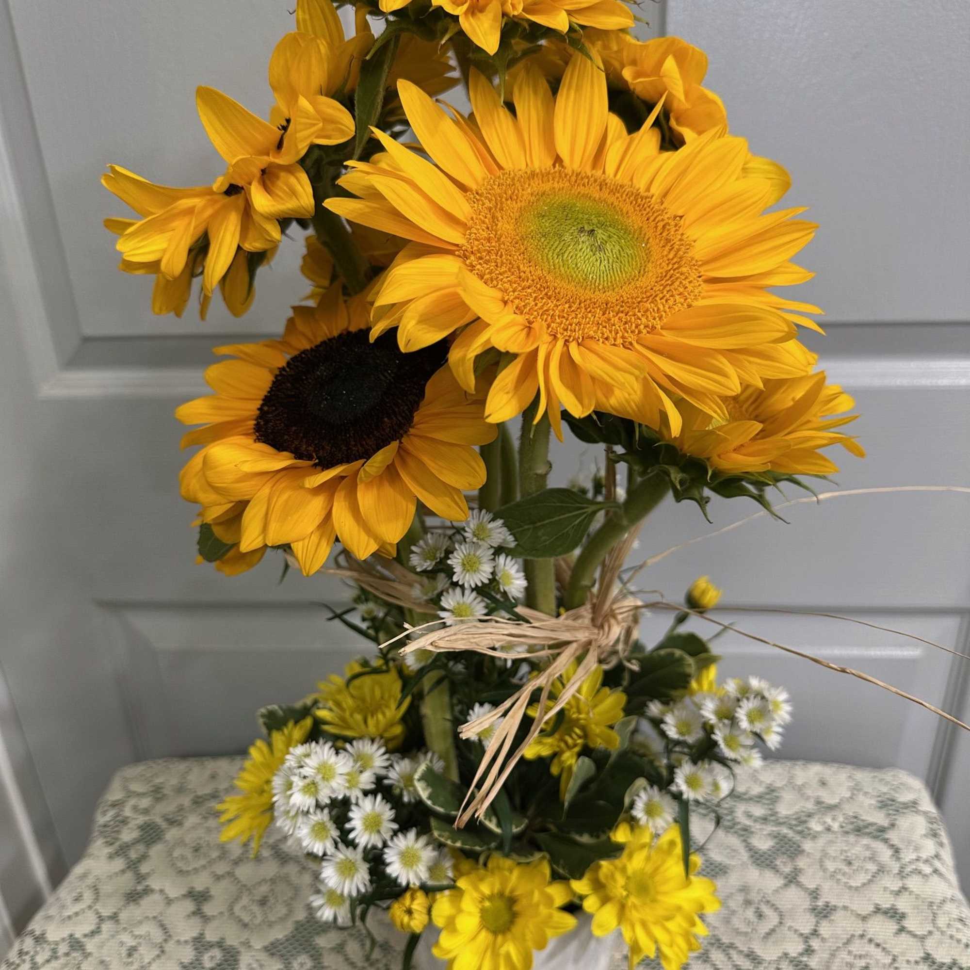 Topiary constructed of Sunflowers, Roses &amp; Assorted  Greens.
Note:   There
