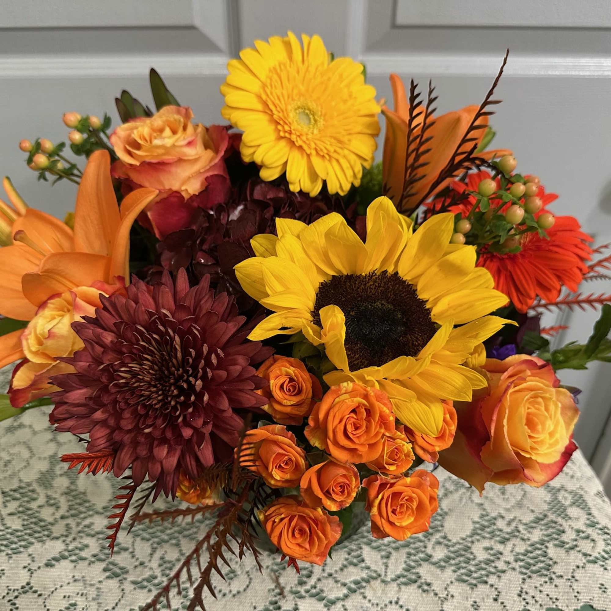 Sunflowers, Roses, Touch of Summer, Solidago, Fancy Greens.

Note:   There are