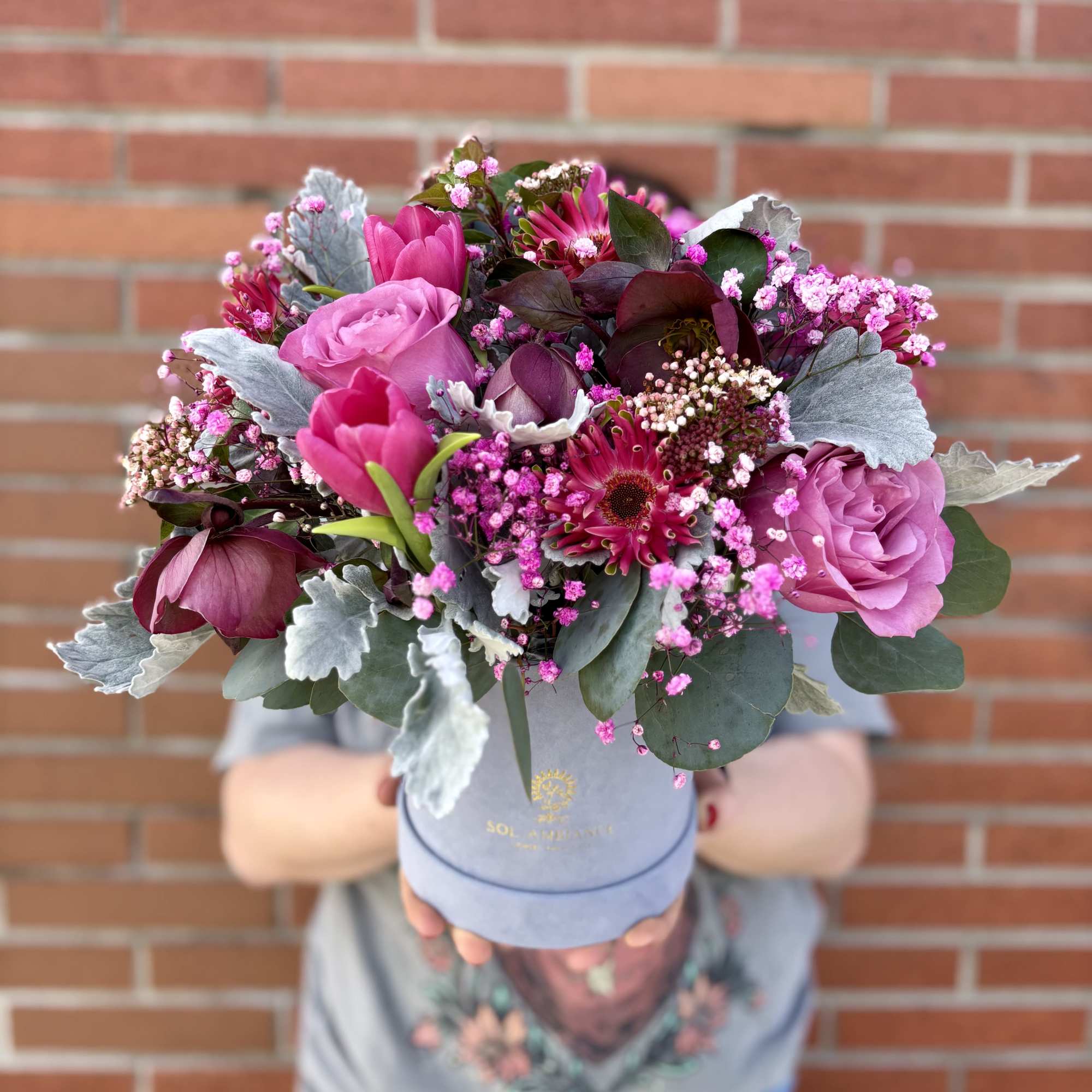 Pink and purple bouquet in a blue hatbox
