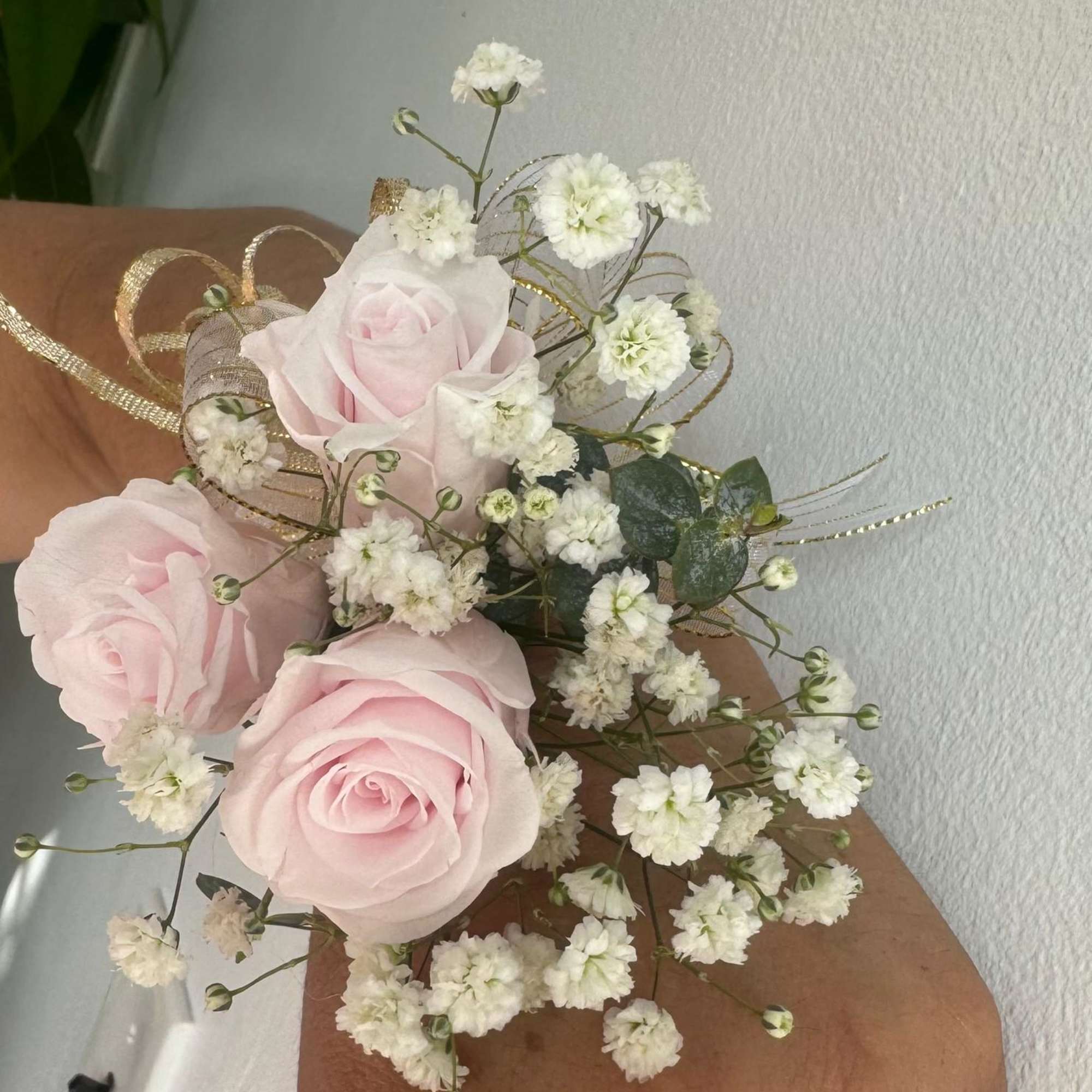 Small bouquet of pale pink roses and white baby's breath