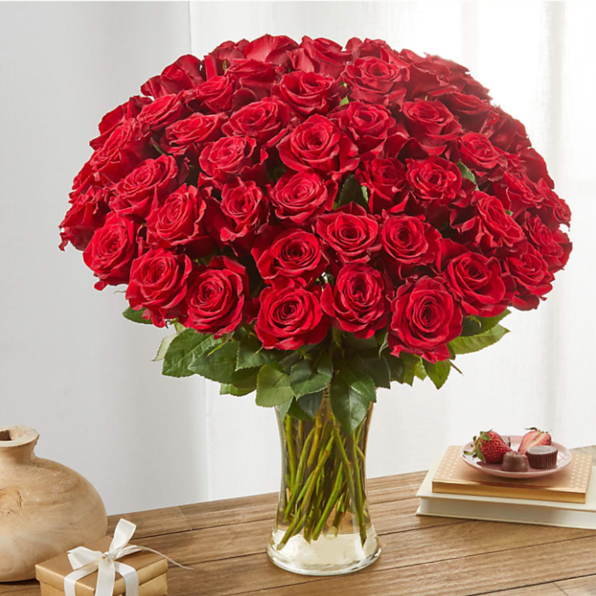 Large bouquet of red roses in a clear glass vase
