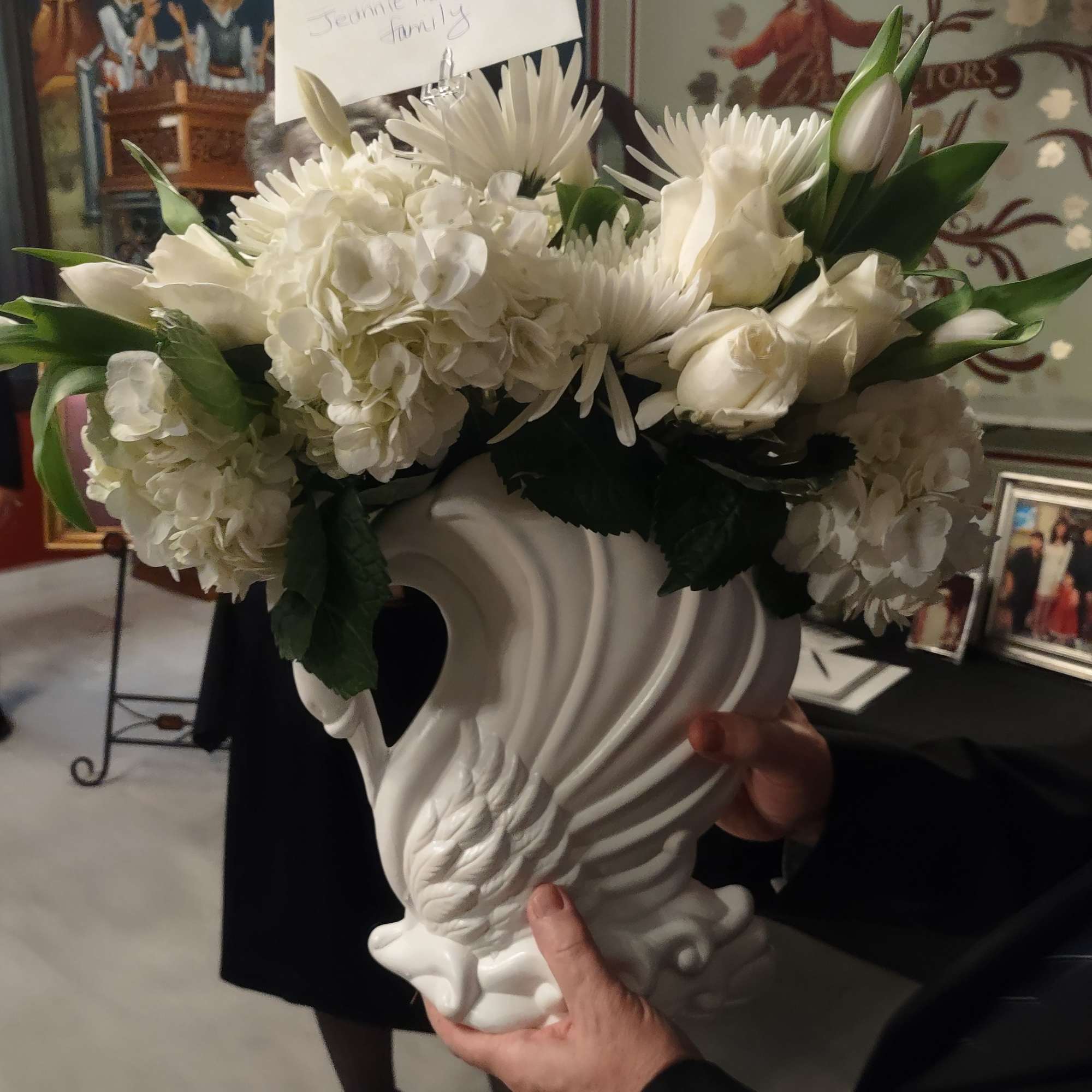 White floral arrangement in a decorative white vase