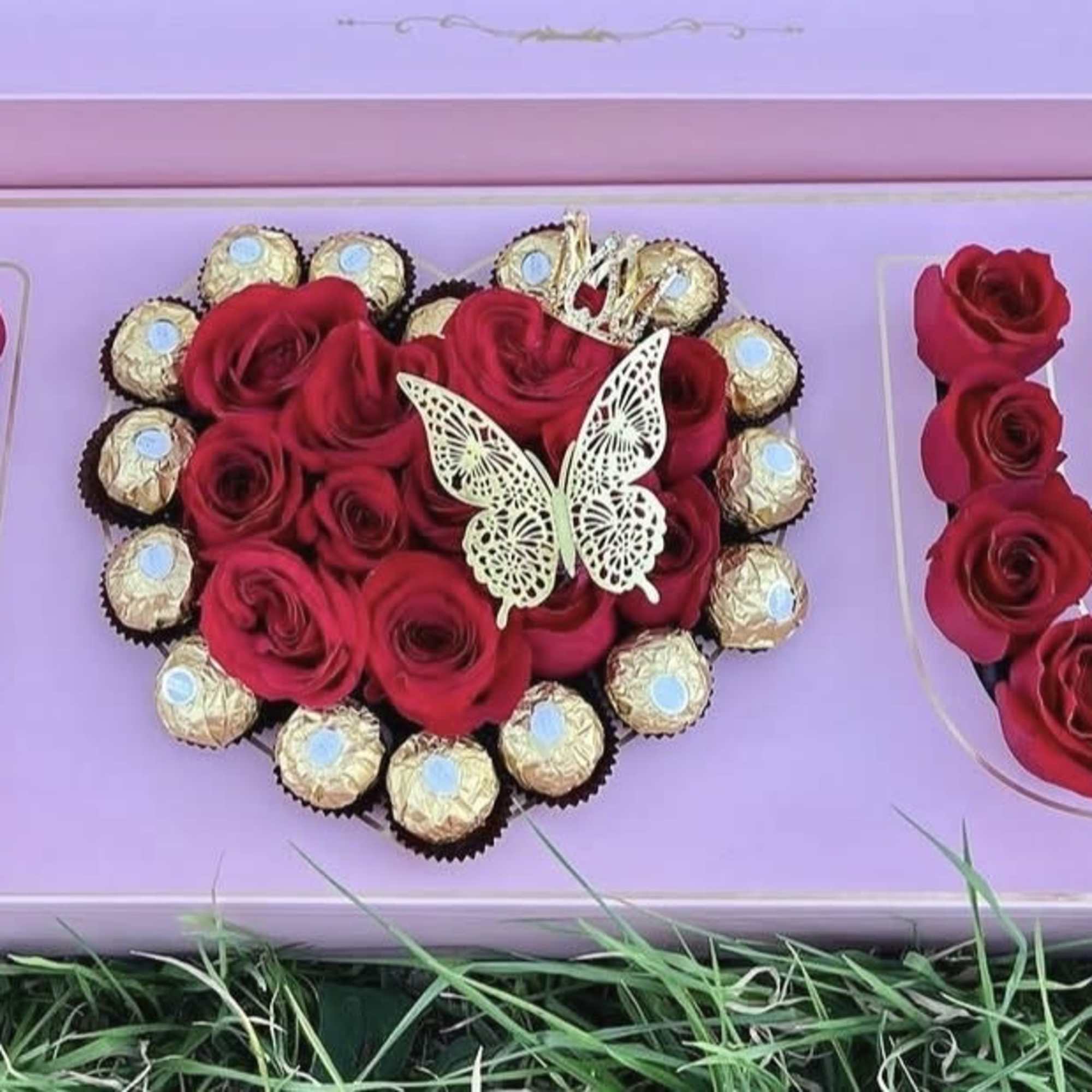 A heart of red roses set inside a pastel pink presentation box-this