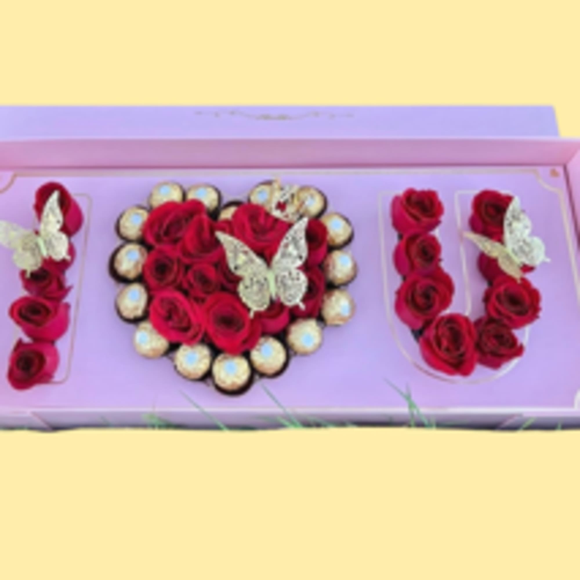 A heart of red roses set inside a pastel pink presentation box-this