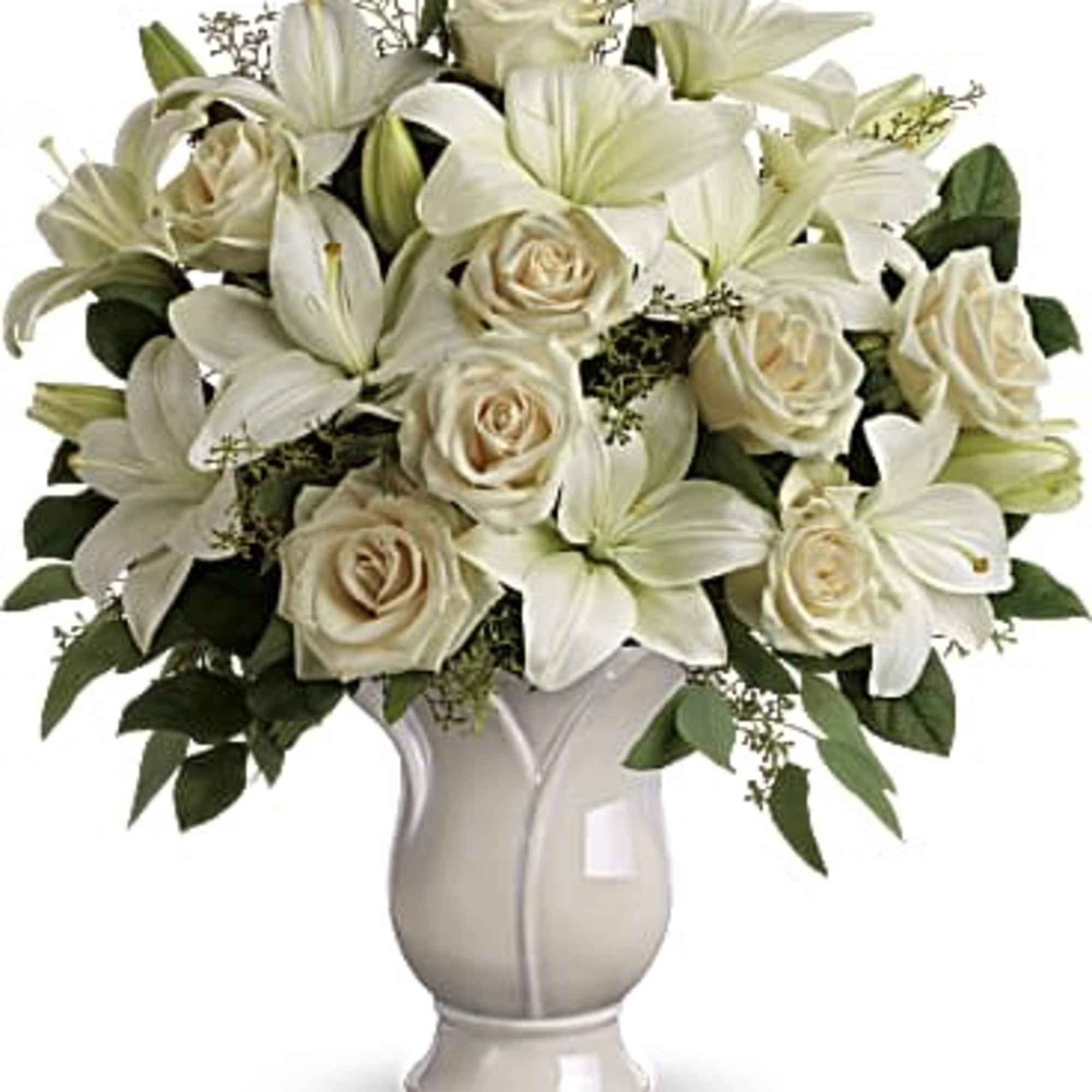 White lilies and cream roses arranged in a vase