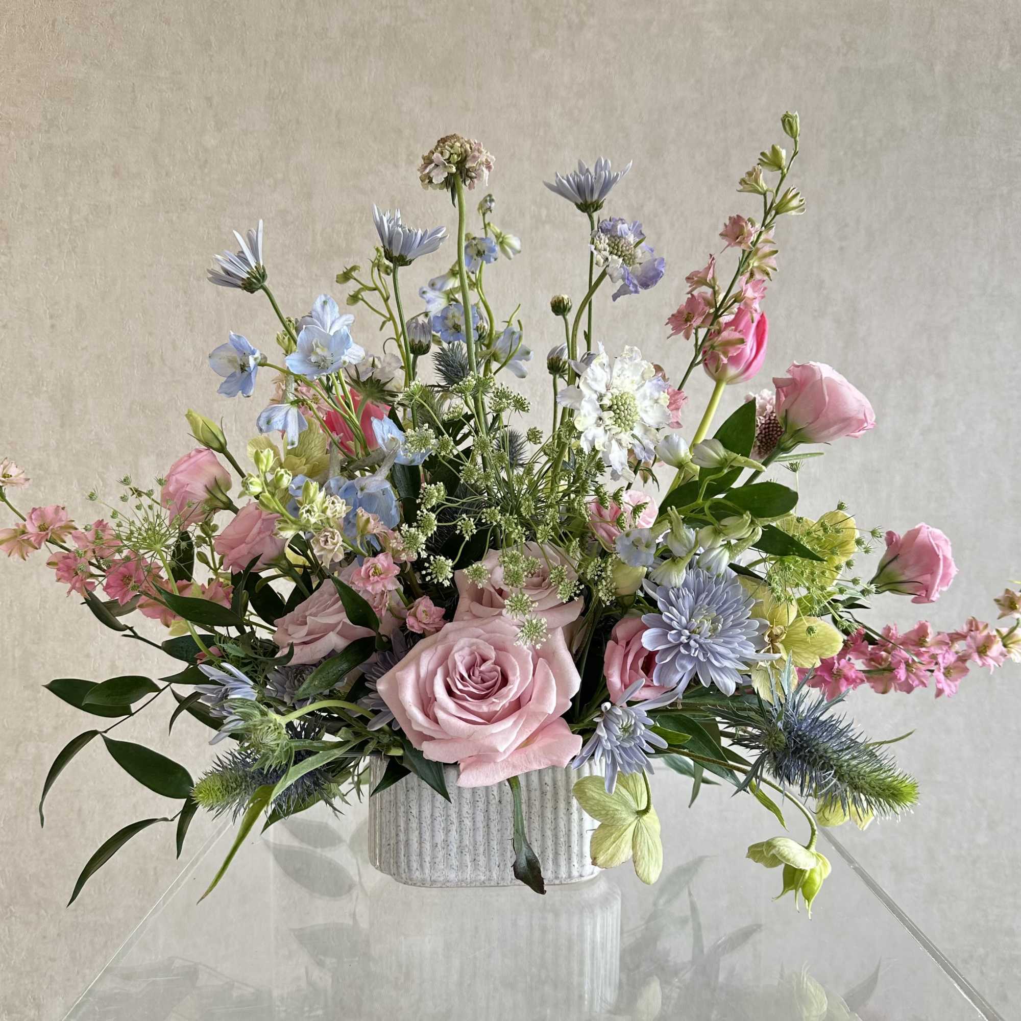 A soft, garden-style arrangement is a pastel flower arrangement perfect for birthdays