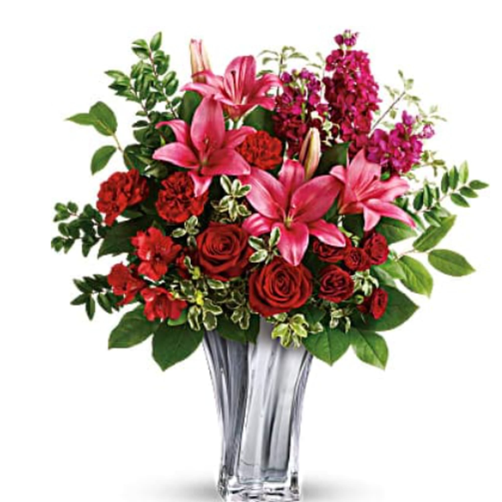 Pink lilies and red roses in a clear glass vase
