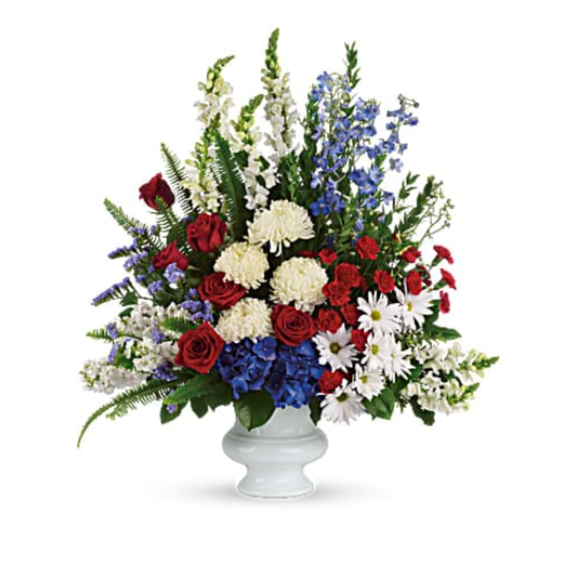 Mixed red, white, and blue flowers arranged in a white vase
