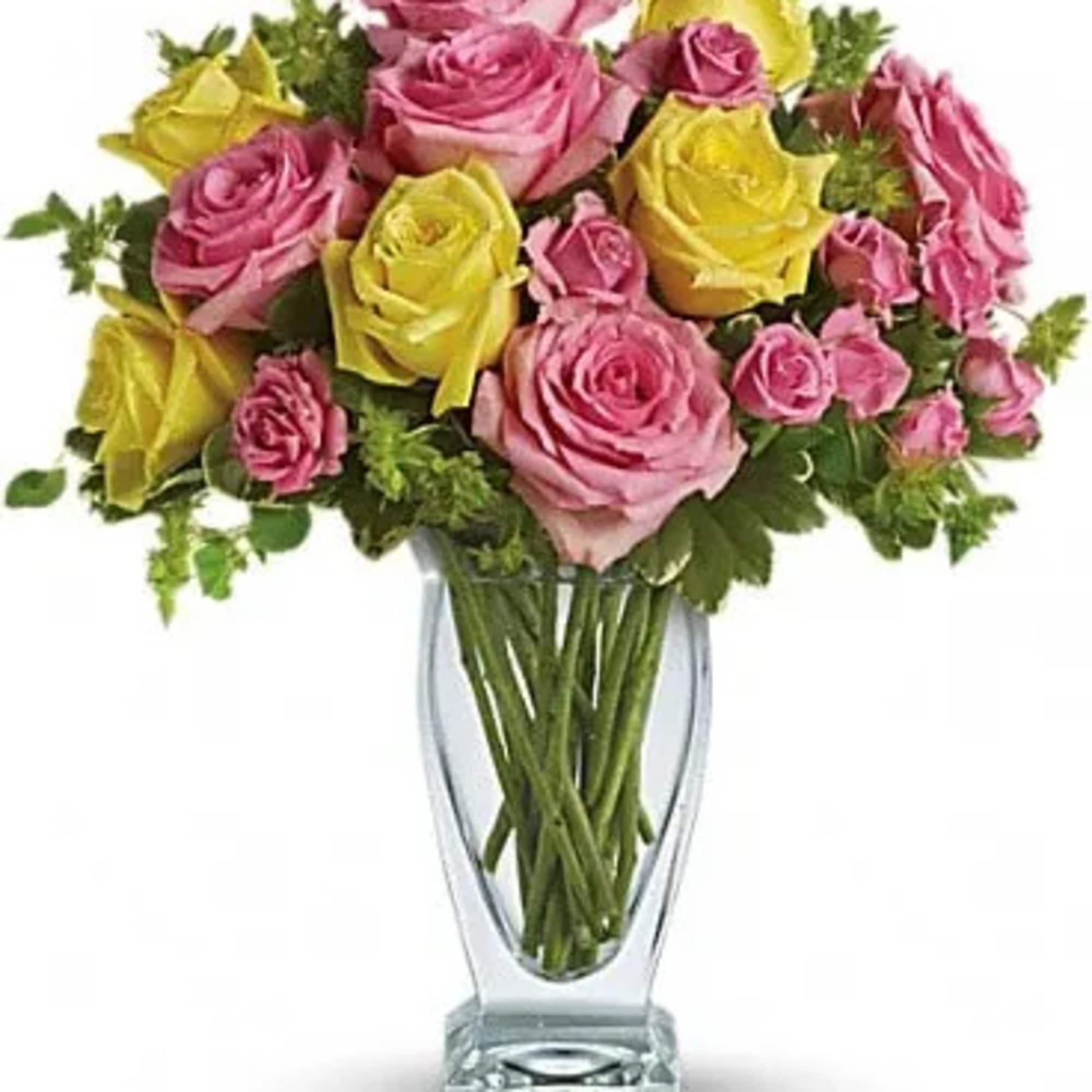 Bouquet of pink and yellow roses in a clear glass vase