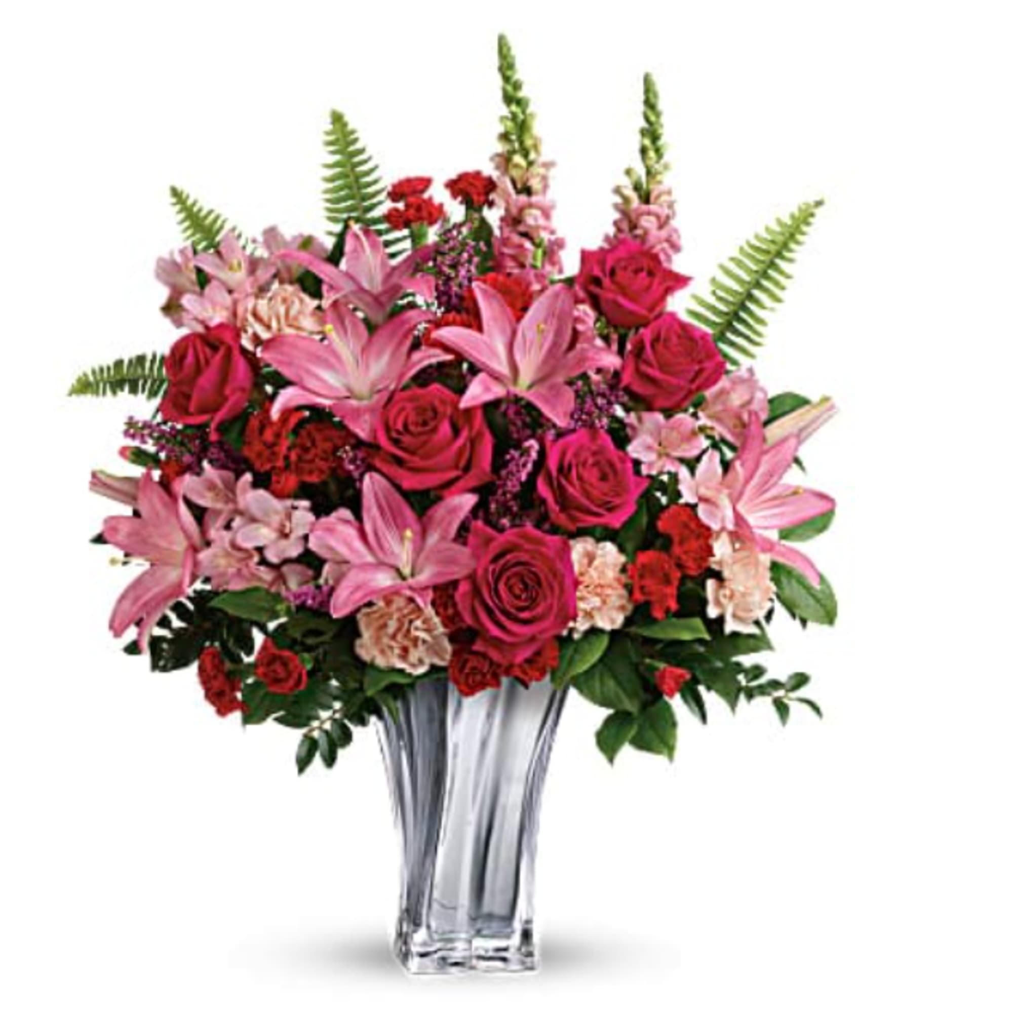Pink lilies and roses arranged in a clear glass vase