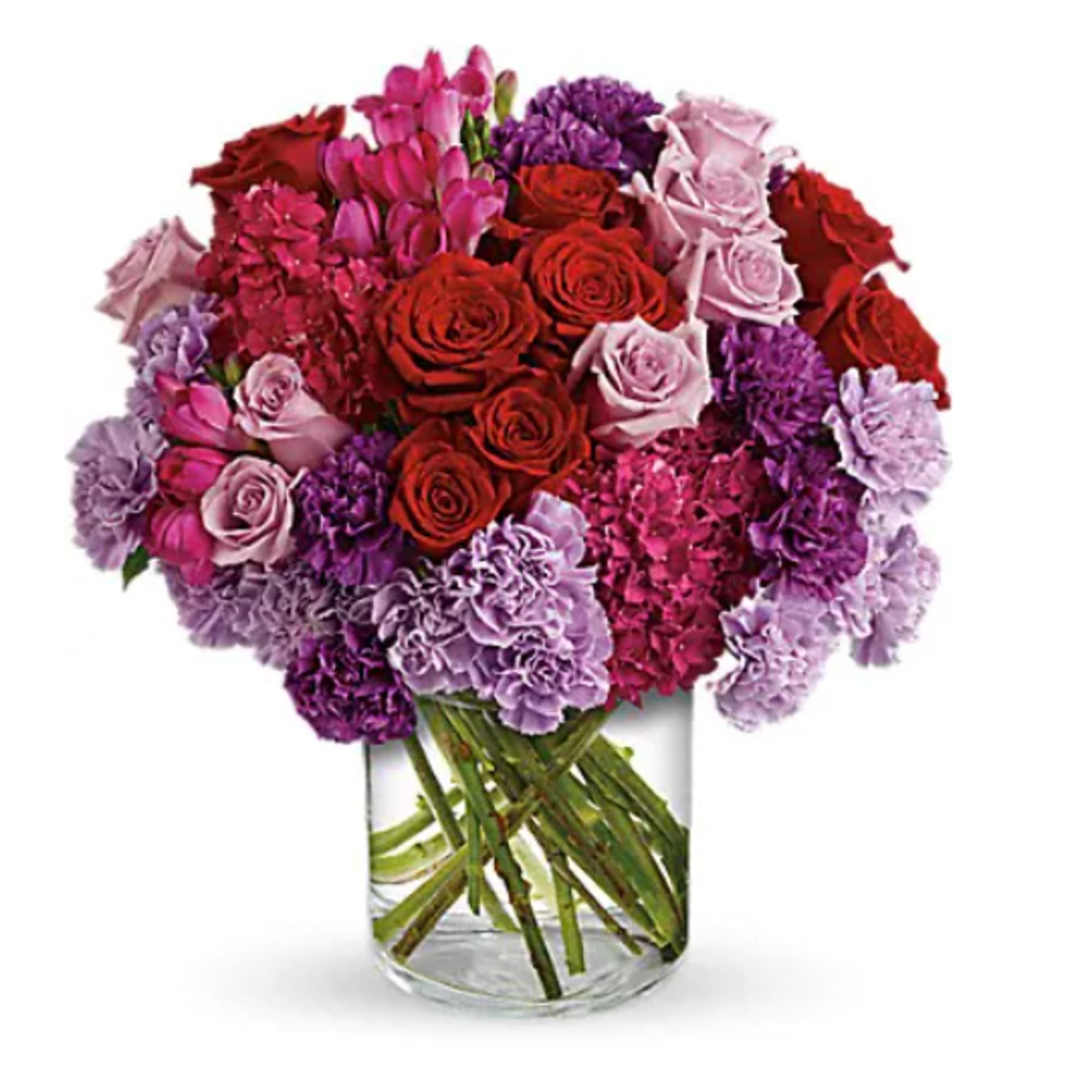 Bouquet of red, pink, and purple flowers in a clear glass vase
