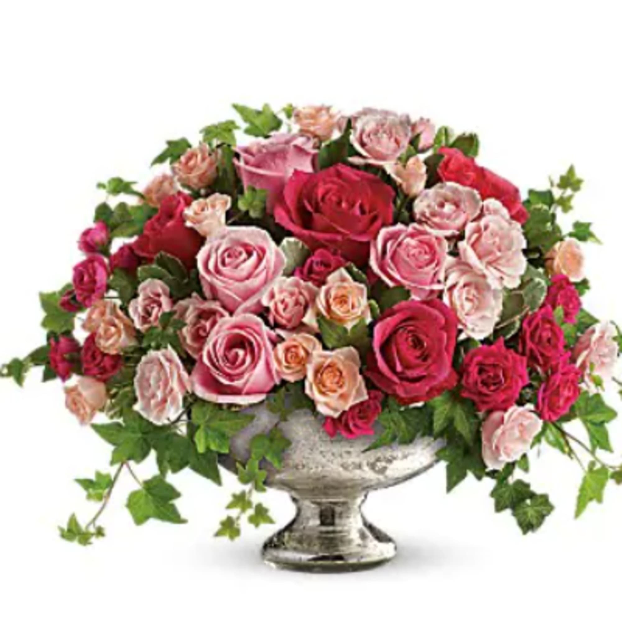 Pink and red rose arrangement in a silver pedestal vase