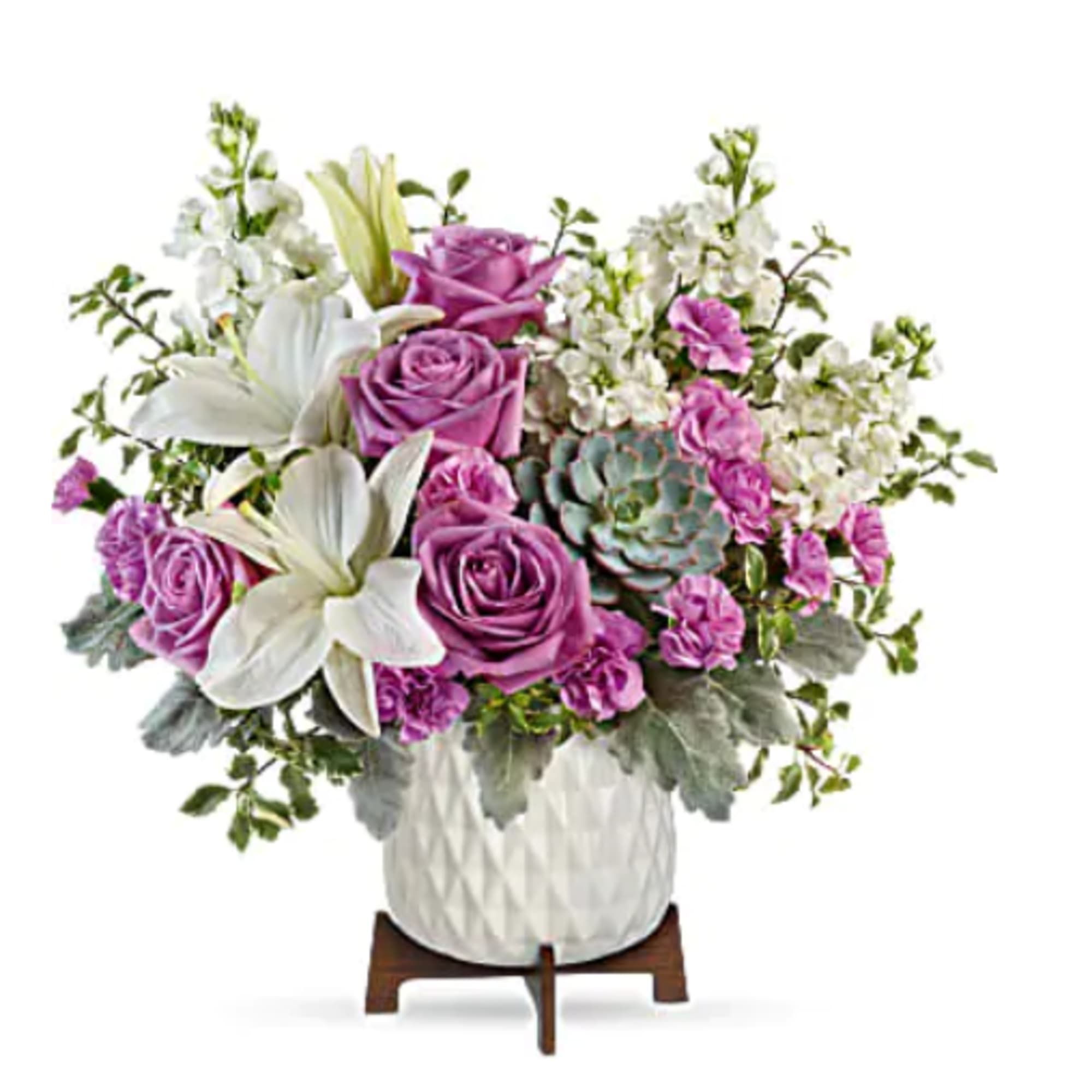 Lavender roses, white lilies, purple blooms, and a succulent in a white textured vase on a wooden stand