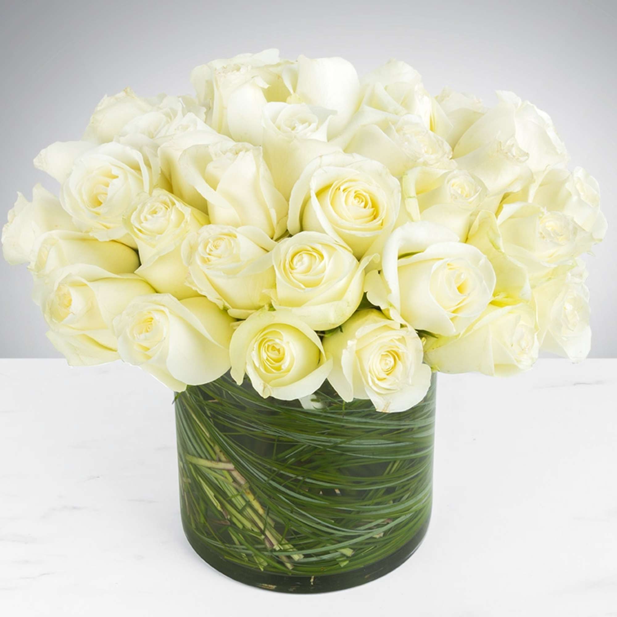 Bouquet of white roses in a clear glass vase