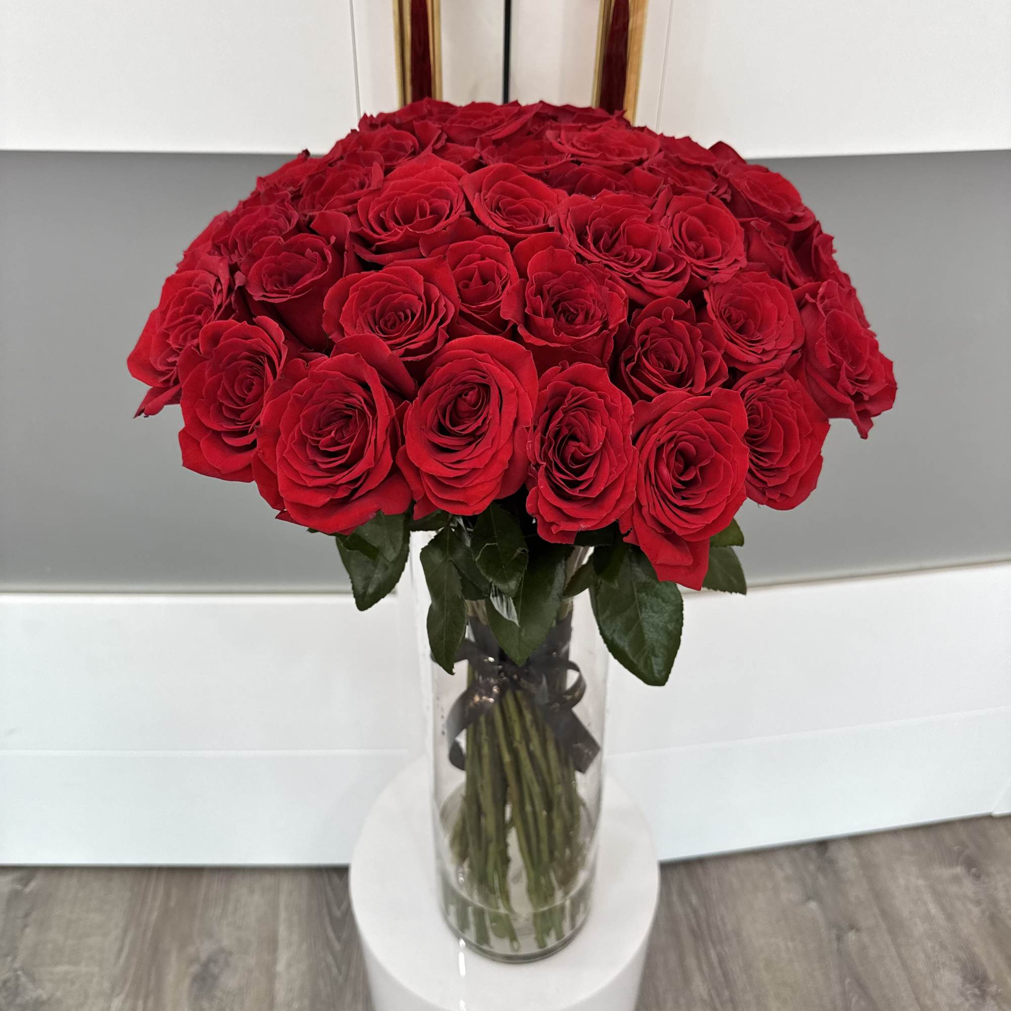Large bouquet of red roses in a clear glass vase