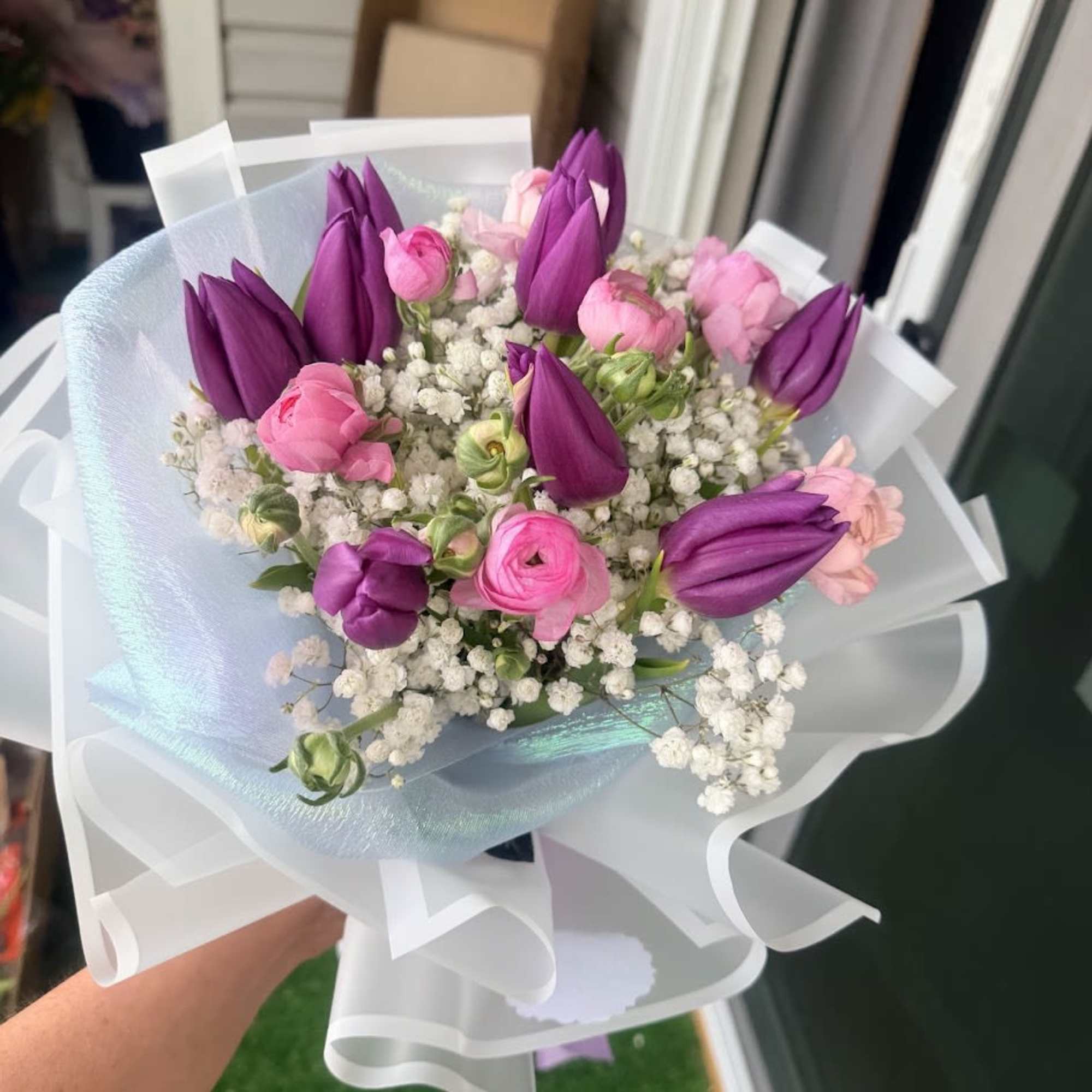 A refined floral arrangement featuring delicate blooms and a beautifully wrapped premium