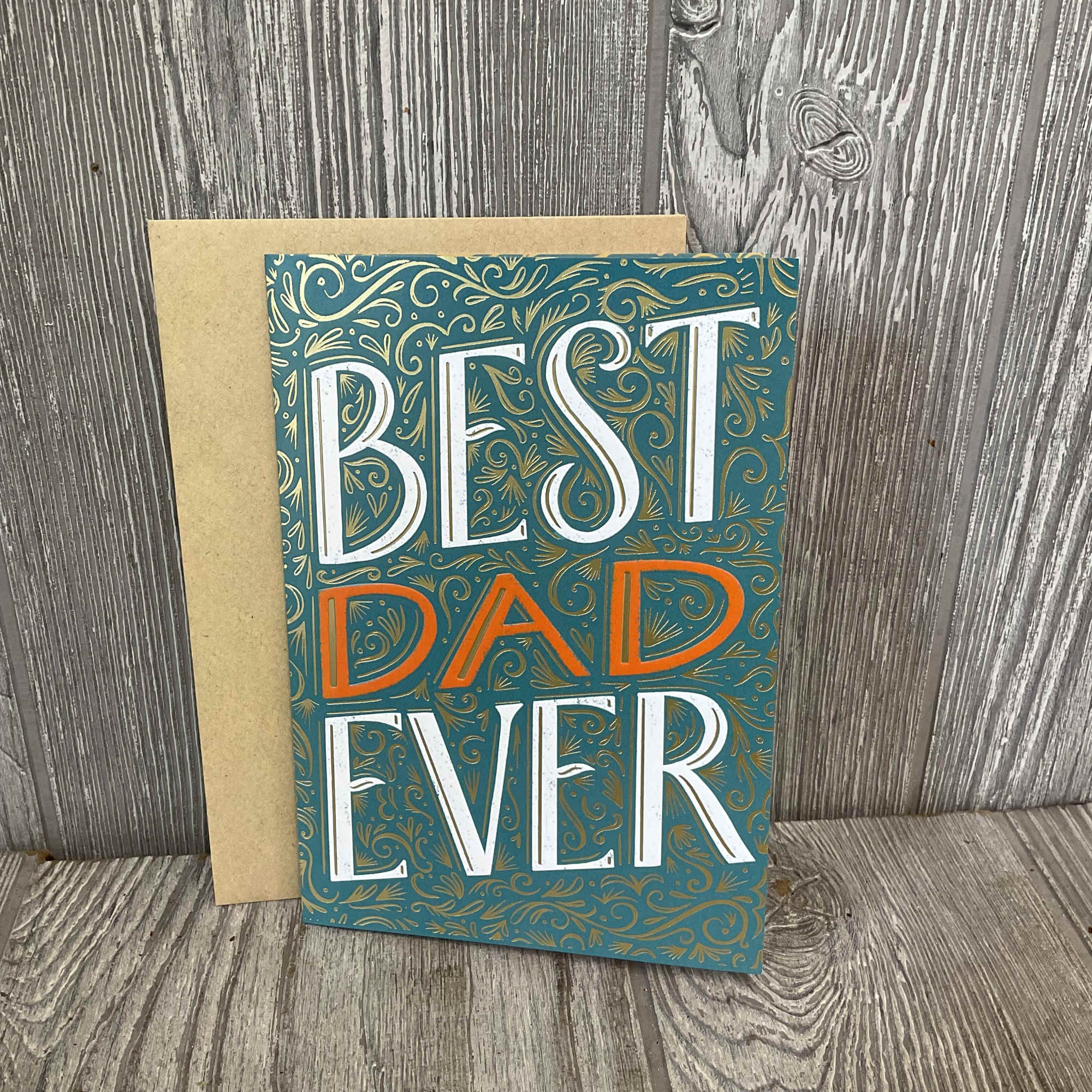 Greeting card reading "BEST DAD EVER" on a kraft envelope