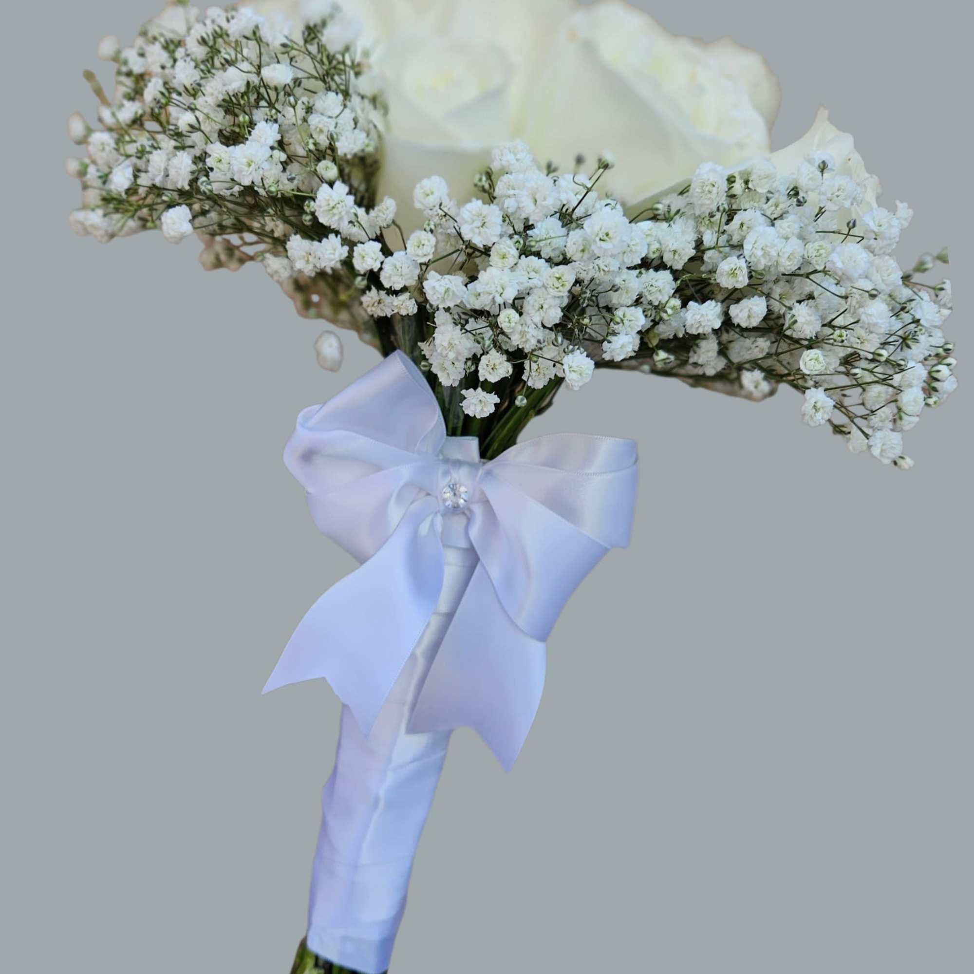 A single large white rose crowned by clouds of baby's breath makes