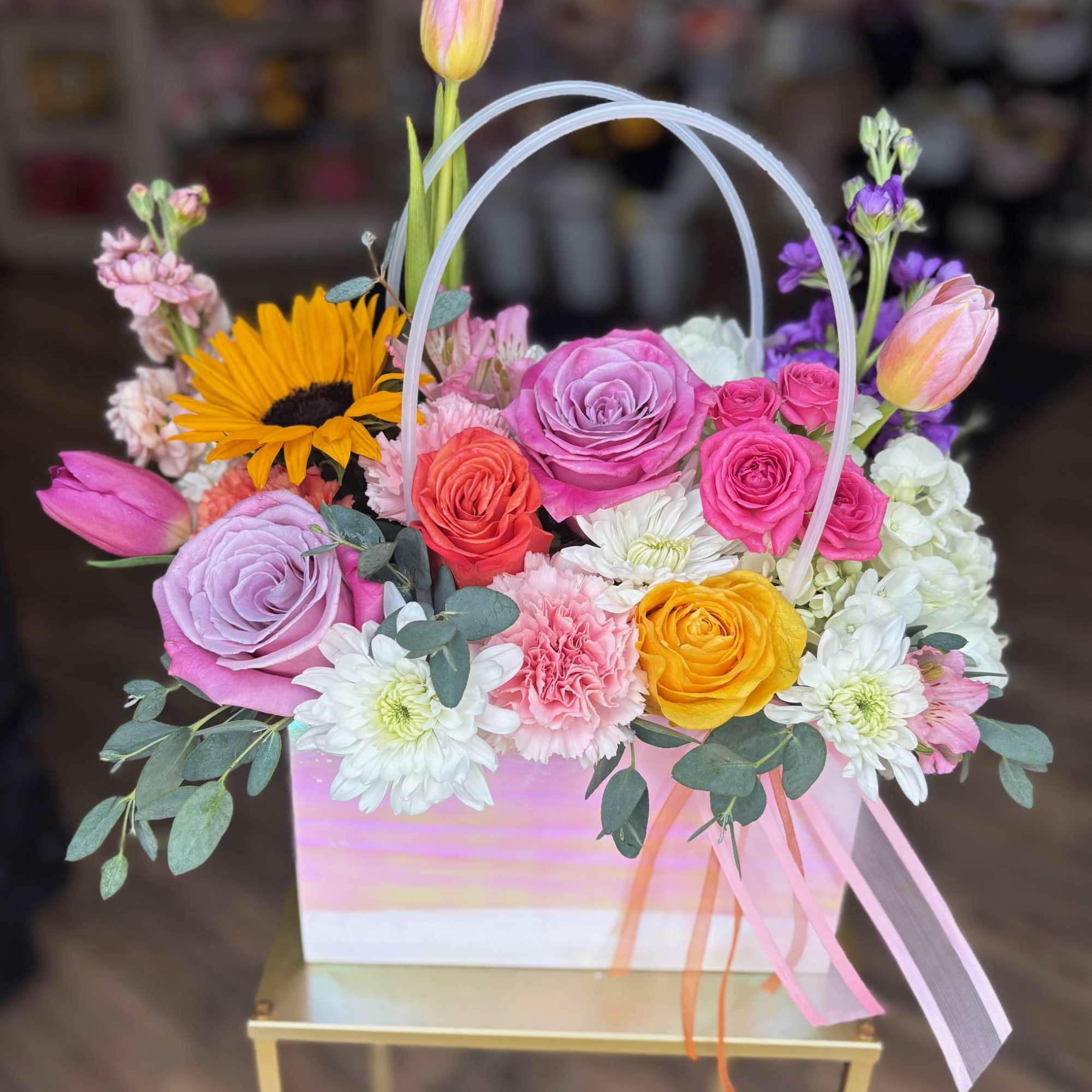 Colorful mixed flower basket with roses, tulips, and daisies
