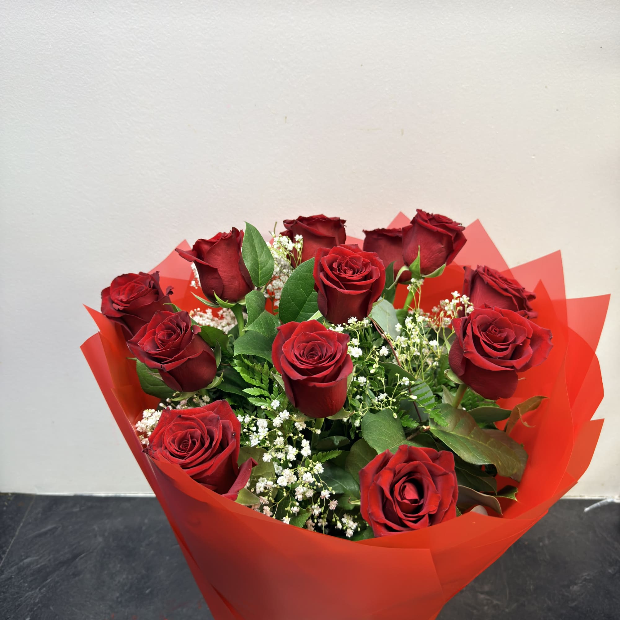 this arrangement is made with fresh roses and wrapped up nice. 