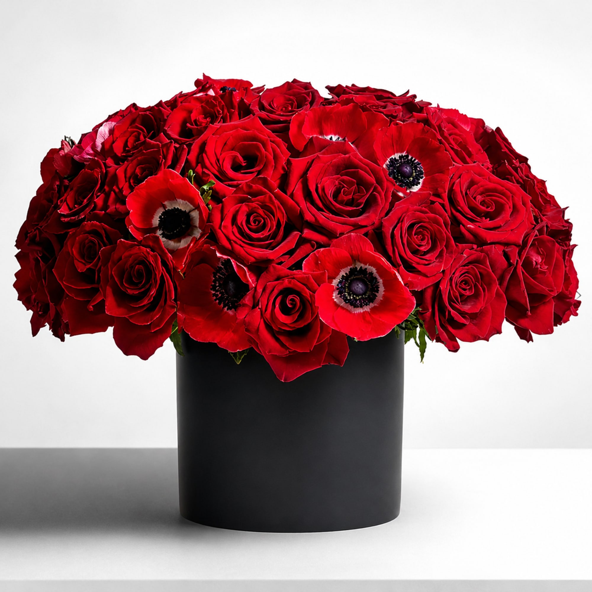 As Shown. A perfect pairing of 36 red Freedom roses, anemone, and