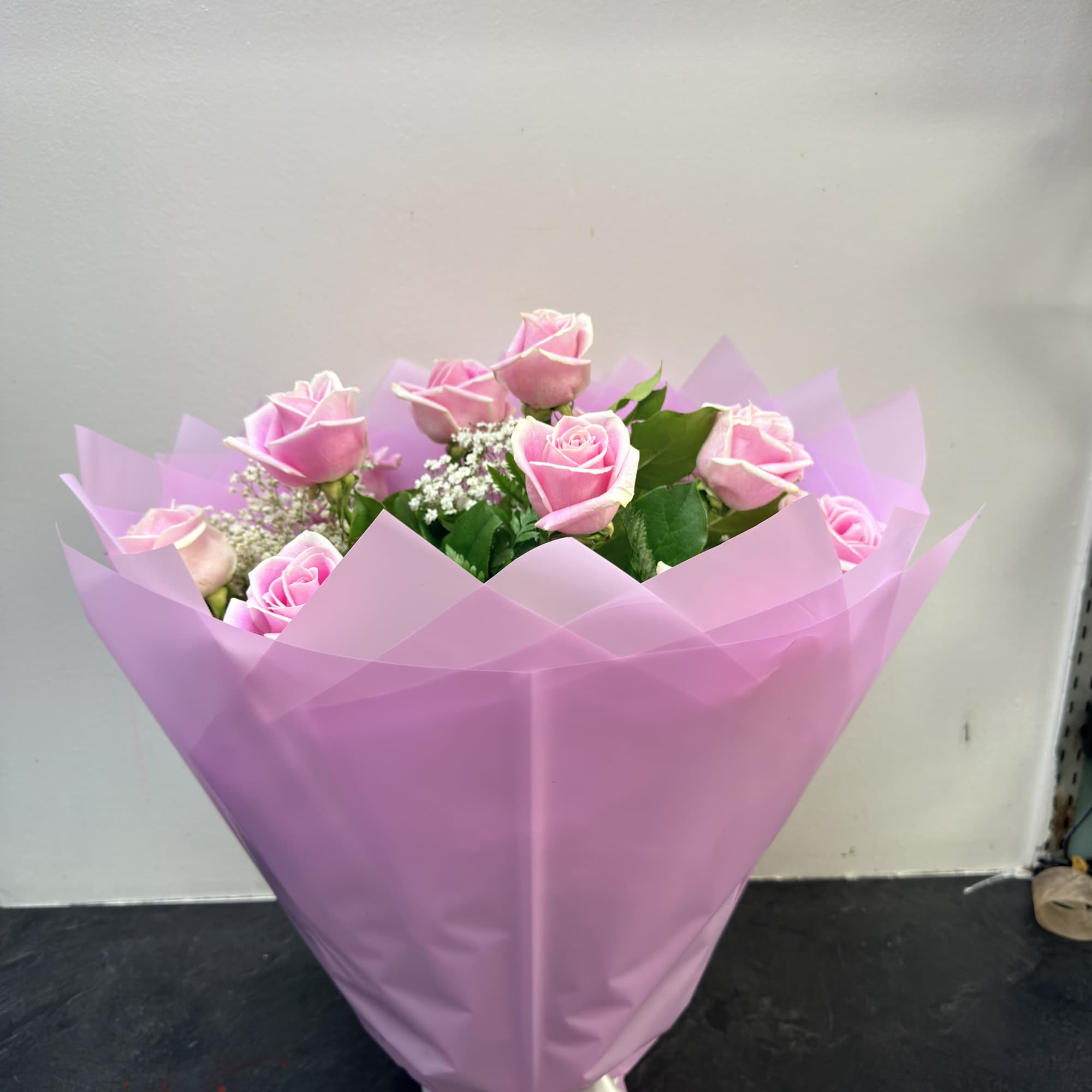 beautiful light pink roses with babies breath and greens, wrapped nice as