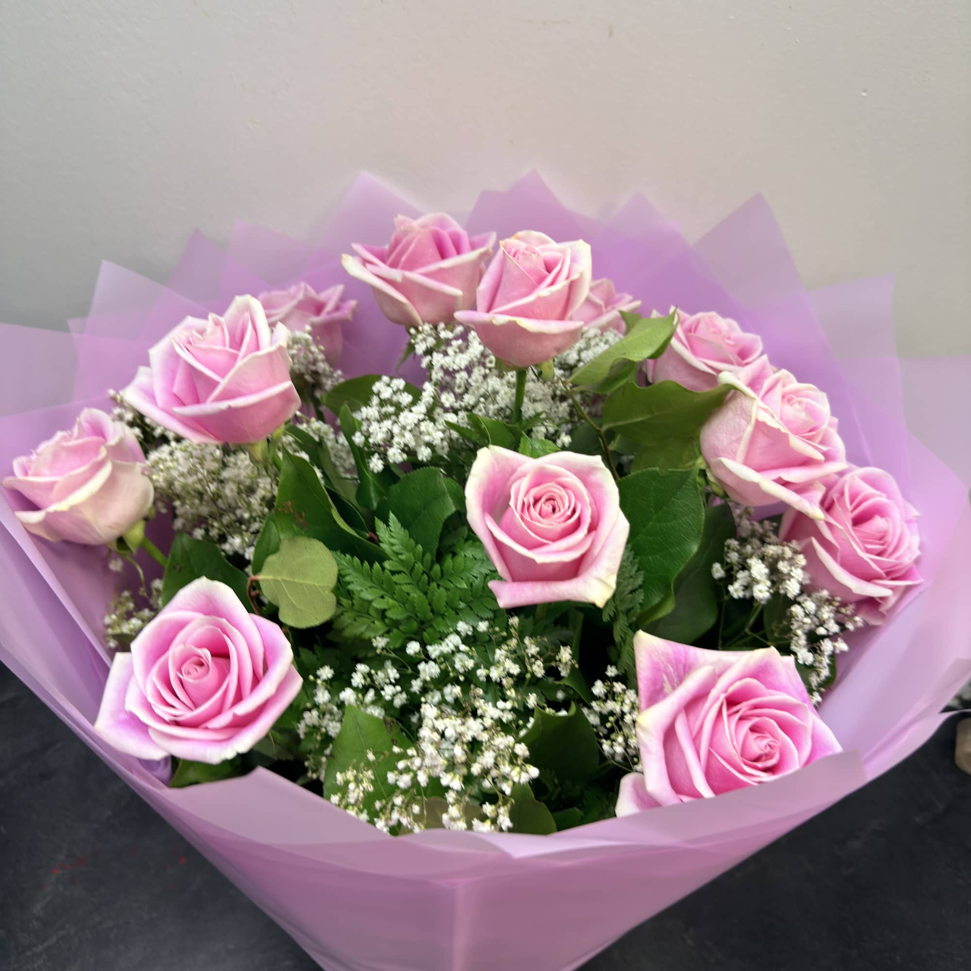 beautiful light pink roses with babies breath and greens, wrapped nice as