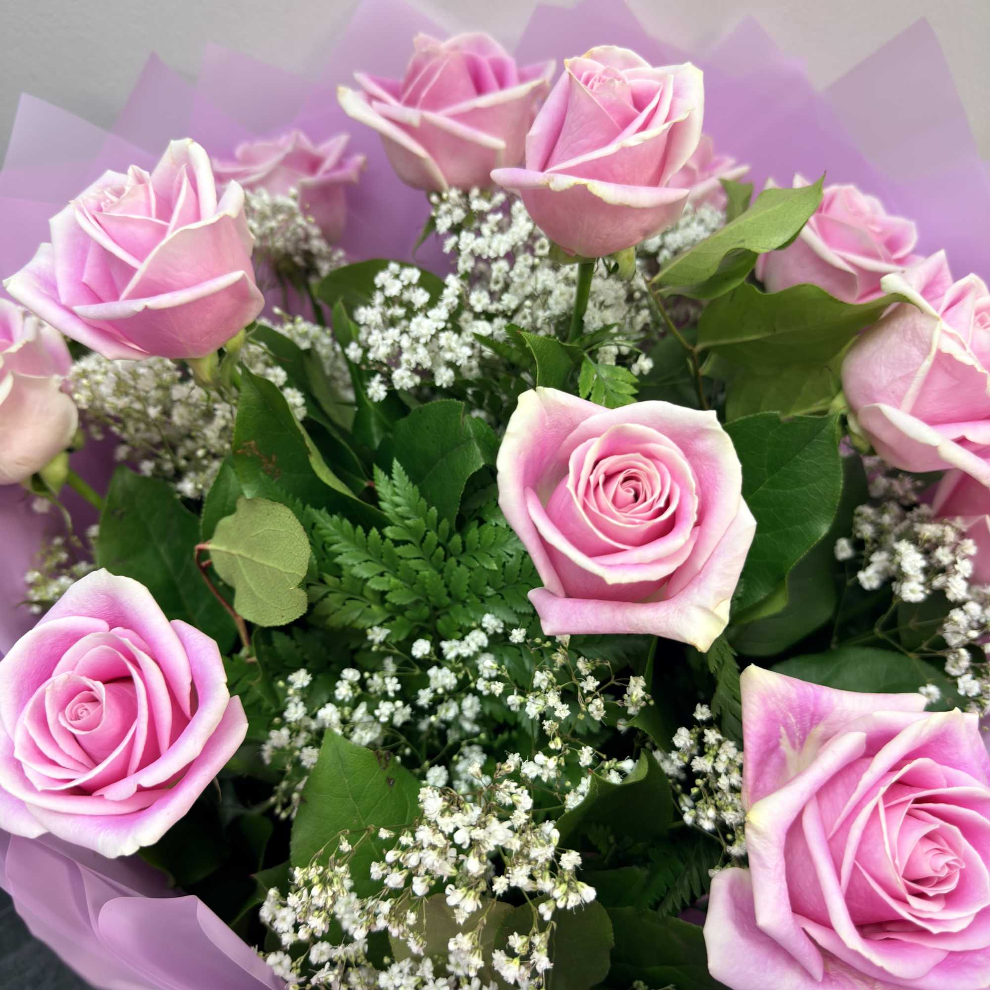 beautiful light pink roses with babies breath and greens, wrapped nice as